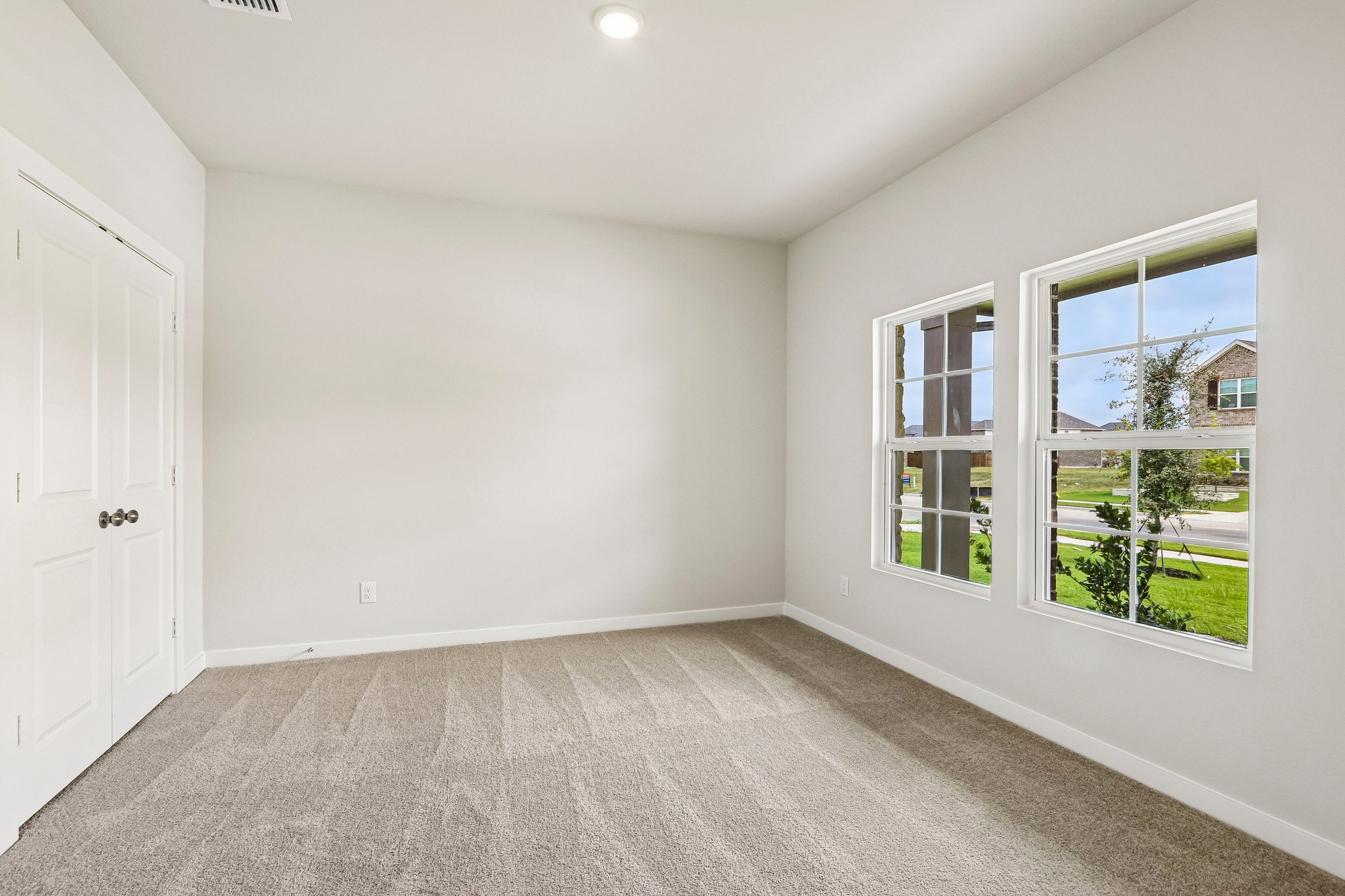 A room with windows and a door.