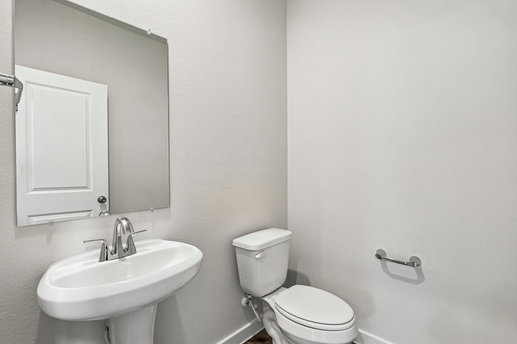 A bathroom with a toilet and sink.