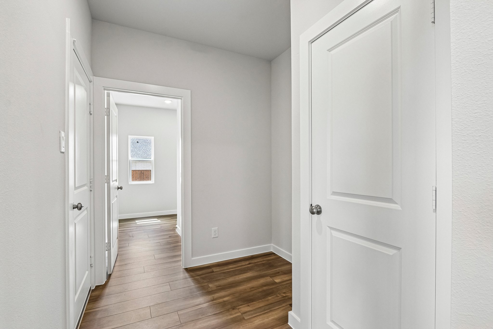 A hallway with white doors.