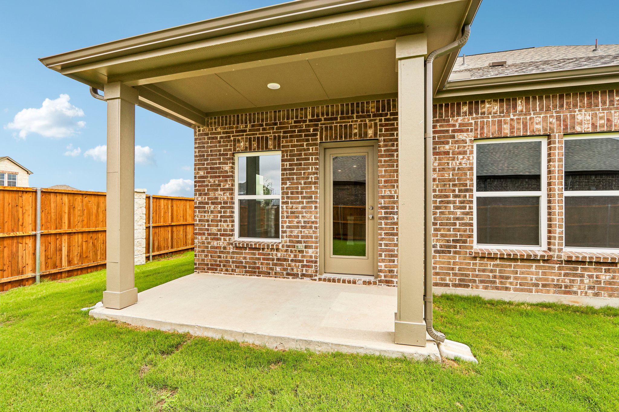 A brick house with a fence.