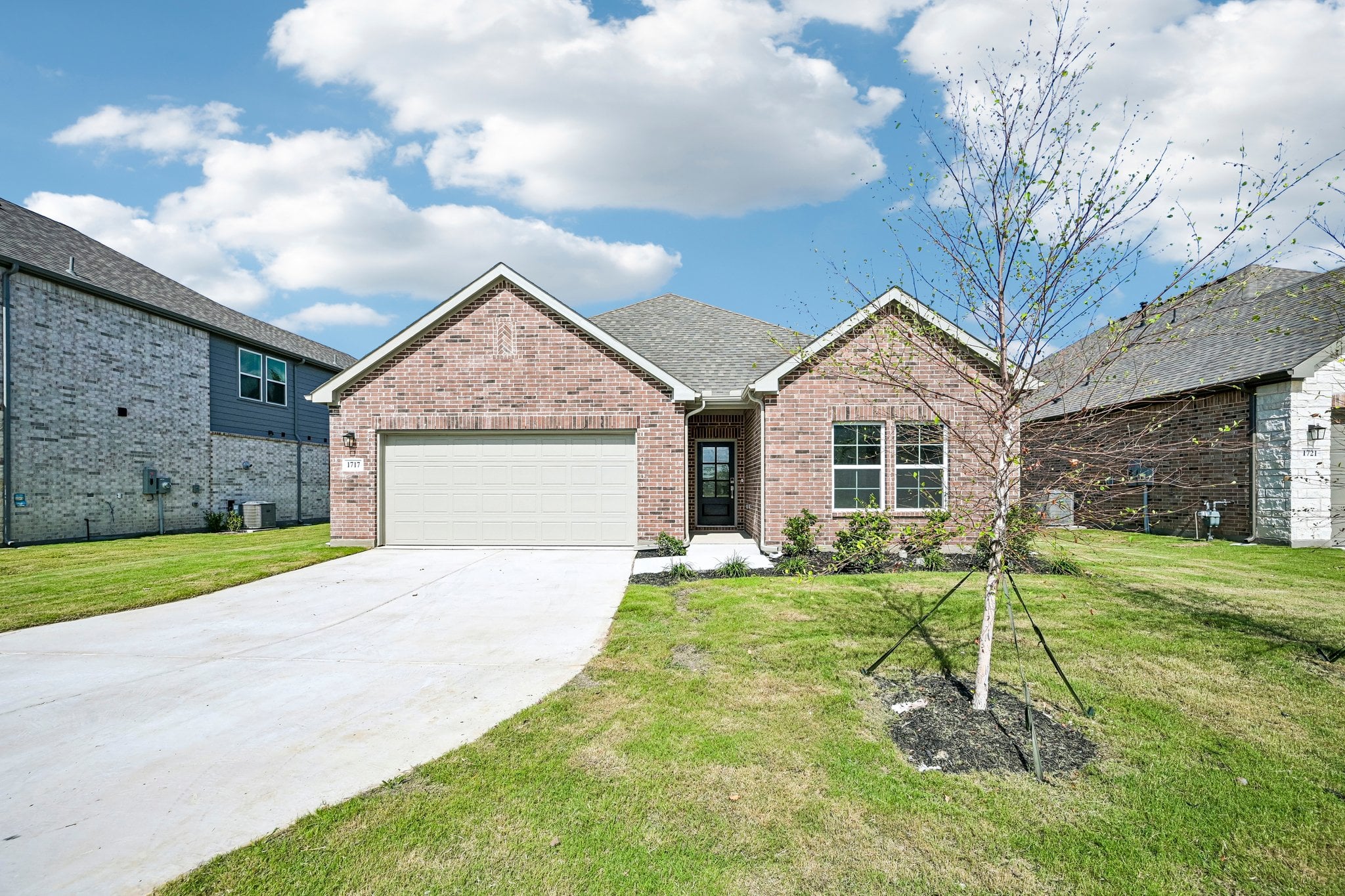 A brick house with a driveway.