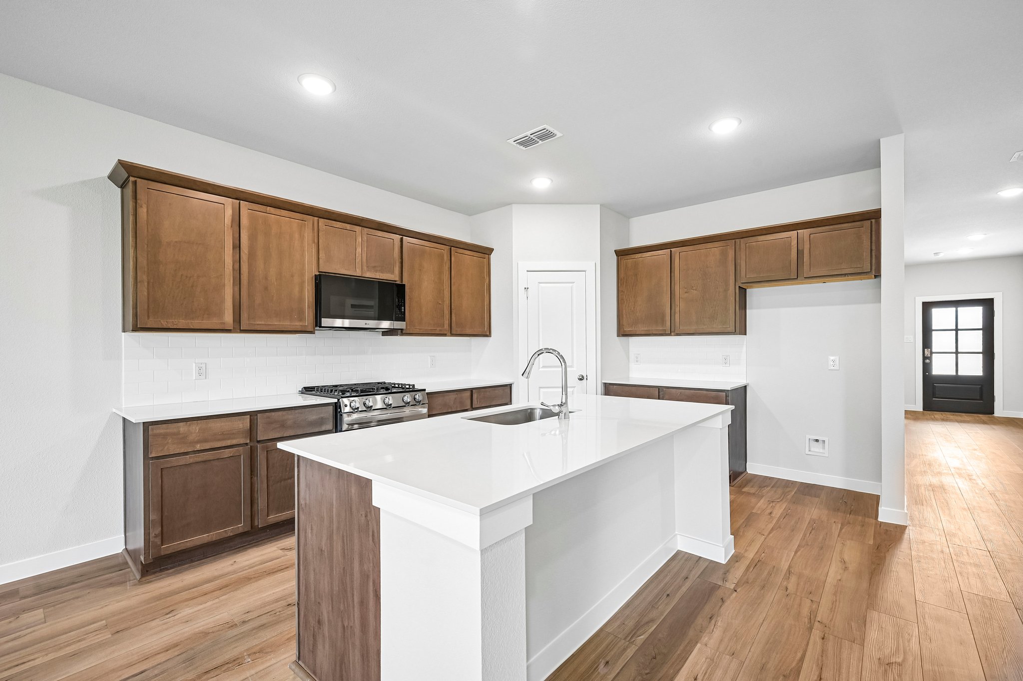 A kitchen with wooden cabinets.