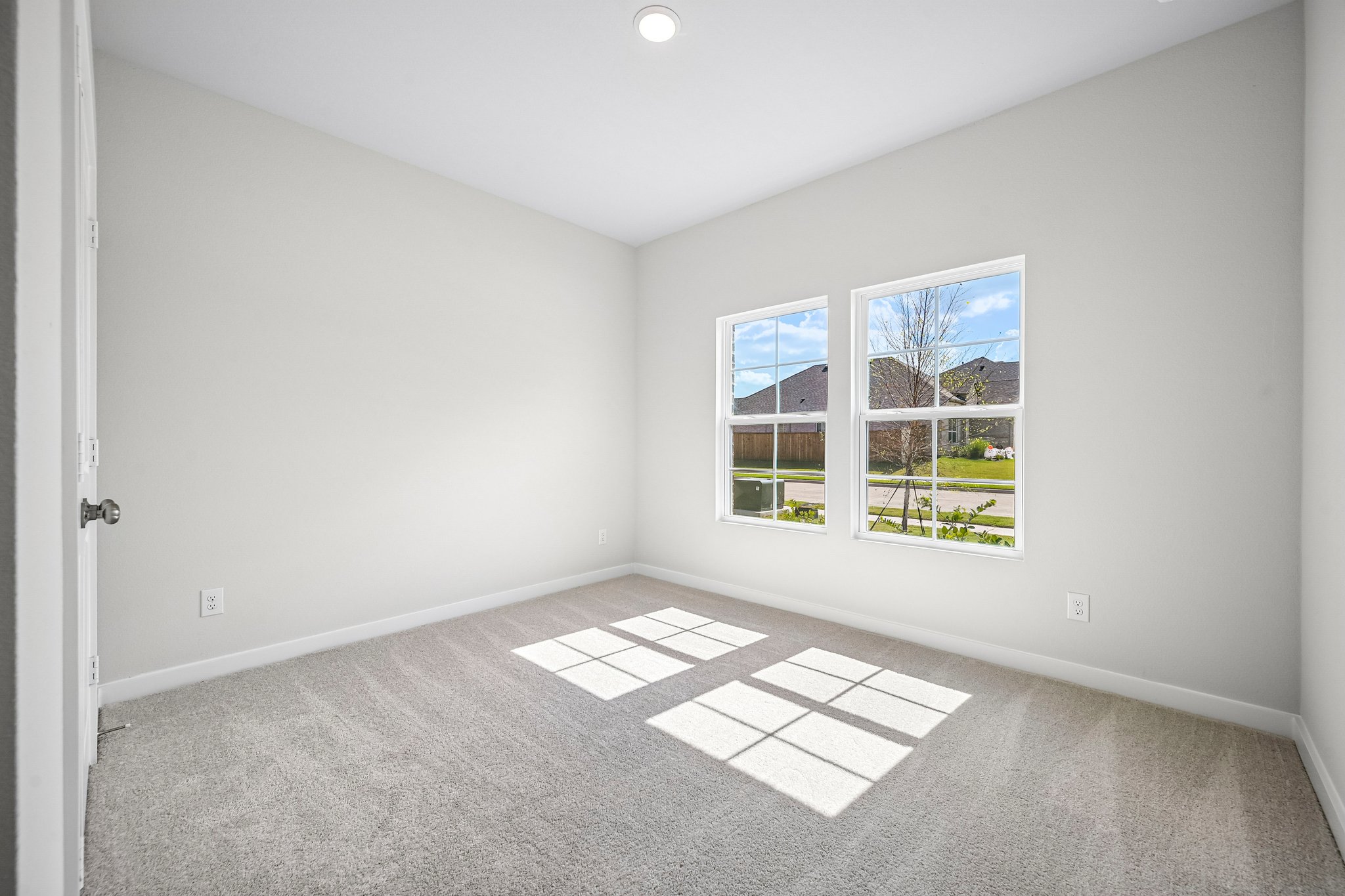 A room with a tile floor and a window with a view of the water.