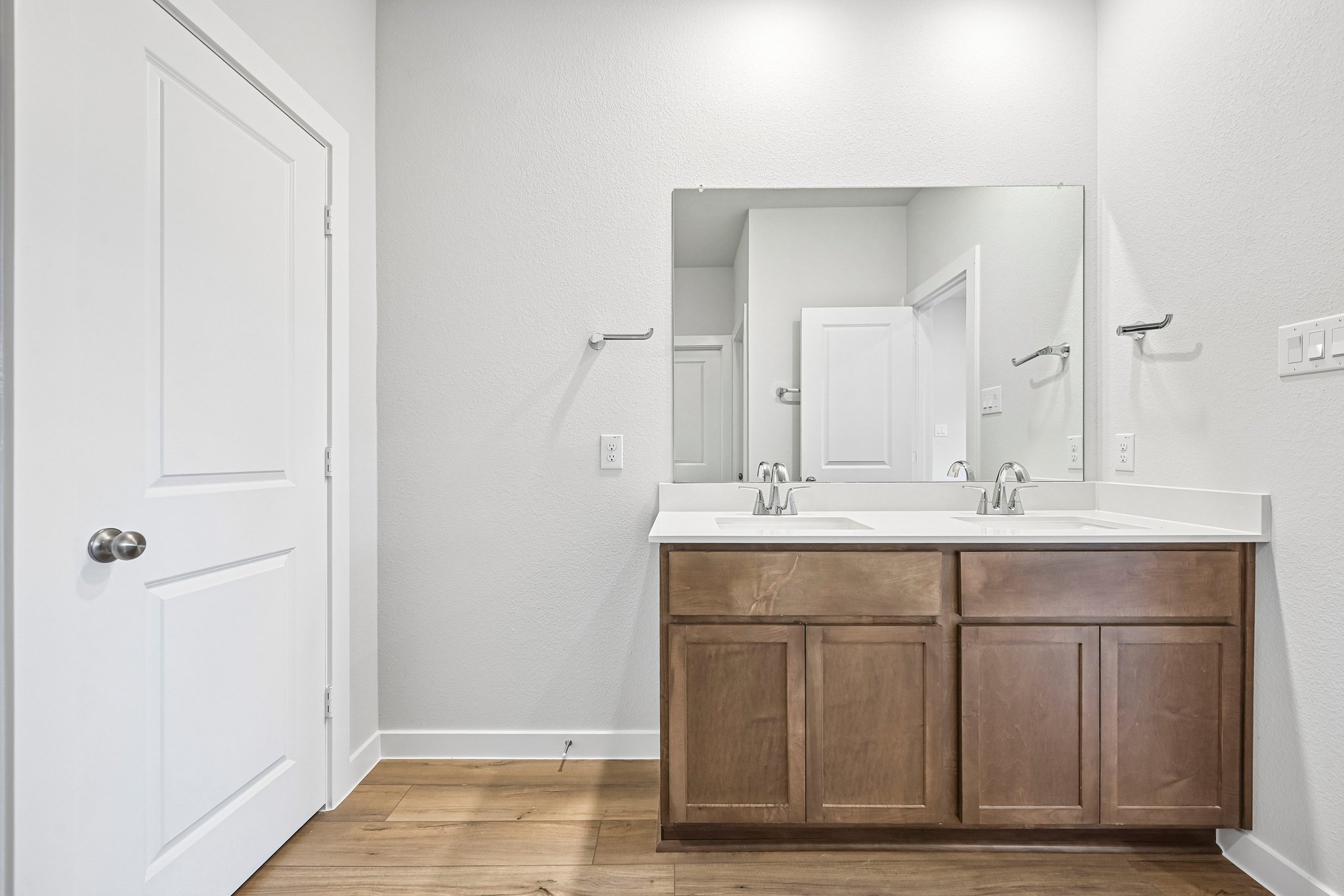 A bathroom with a large mirror.