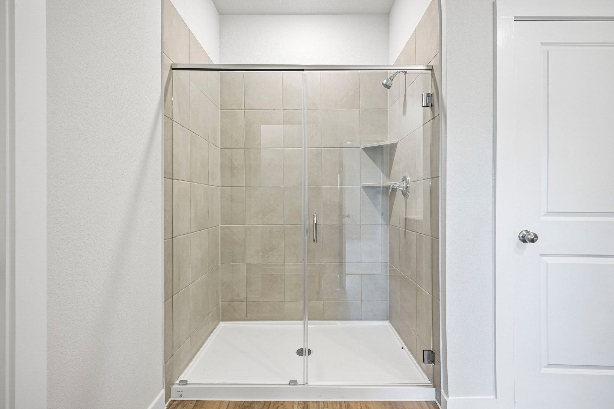 A shower with a glass door.