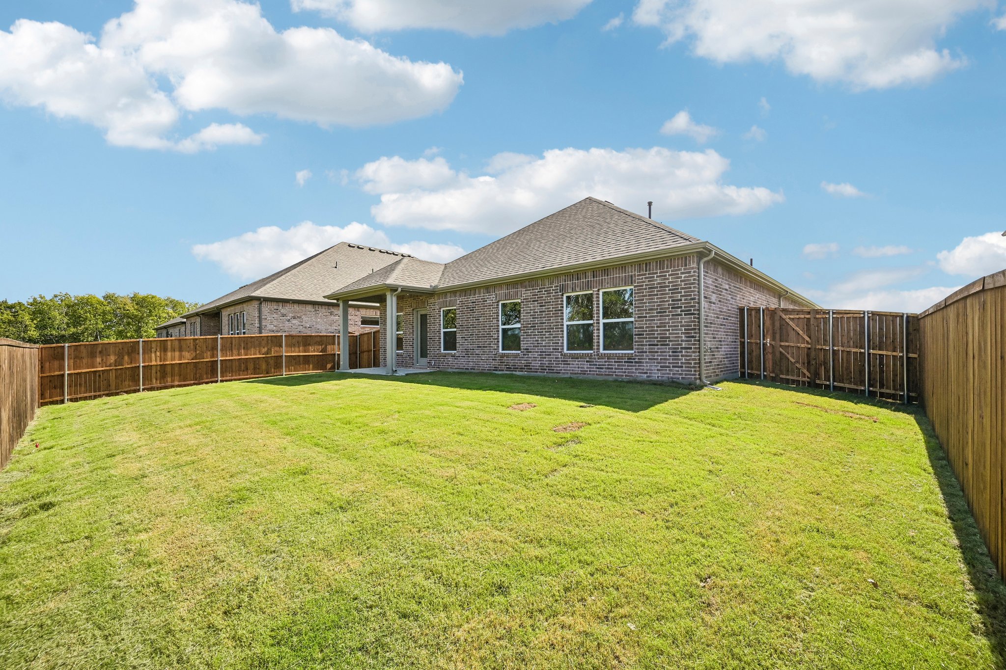 A house with a fence and grass.