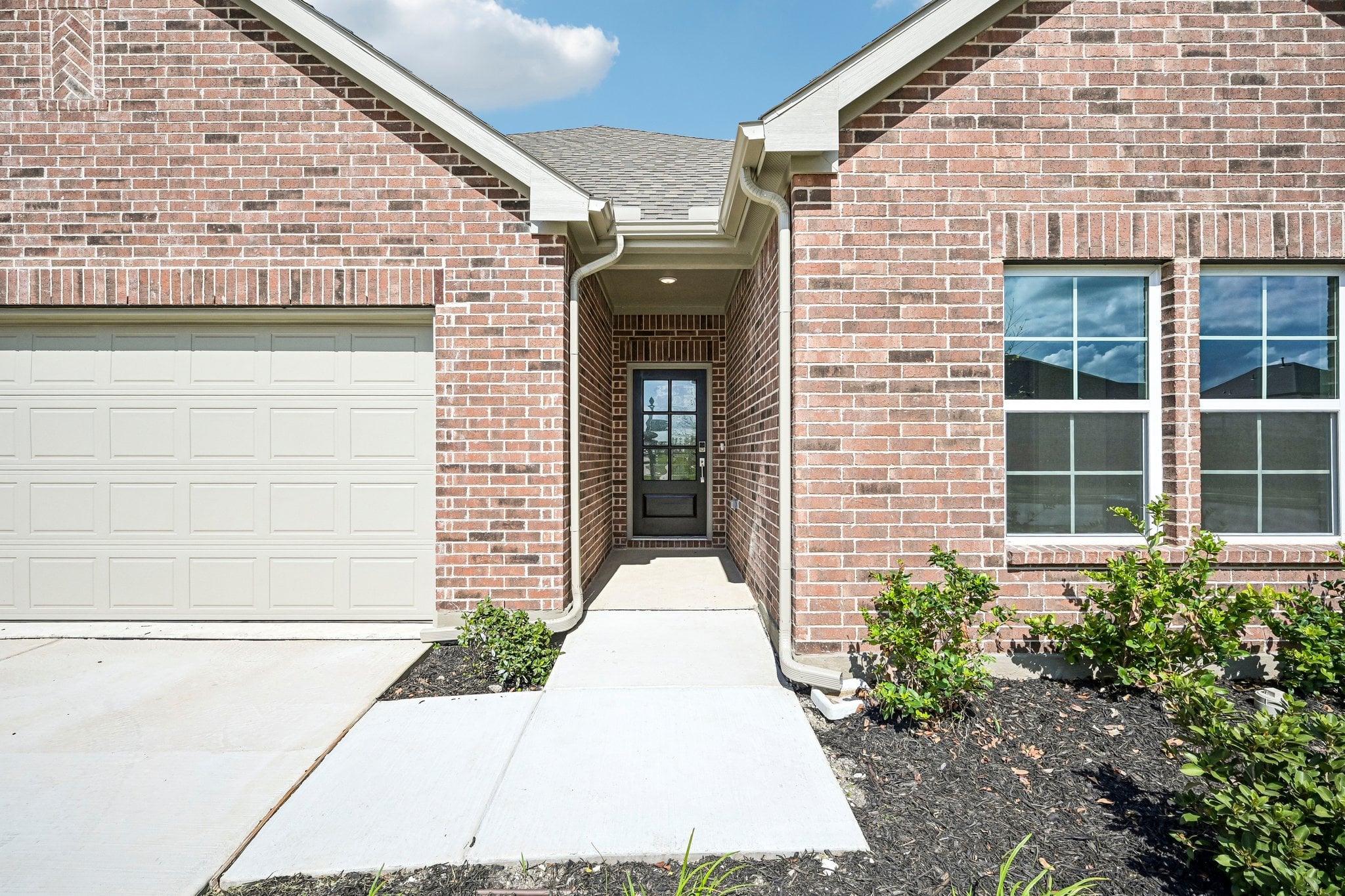 A brick building with a garage.