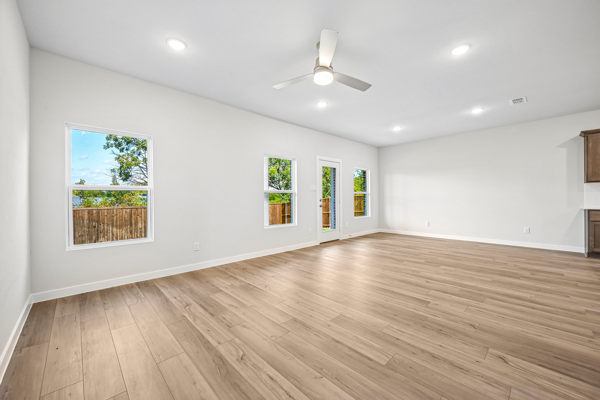 A room with a wood floor and art on the wall.