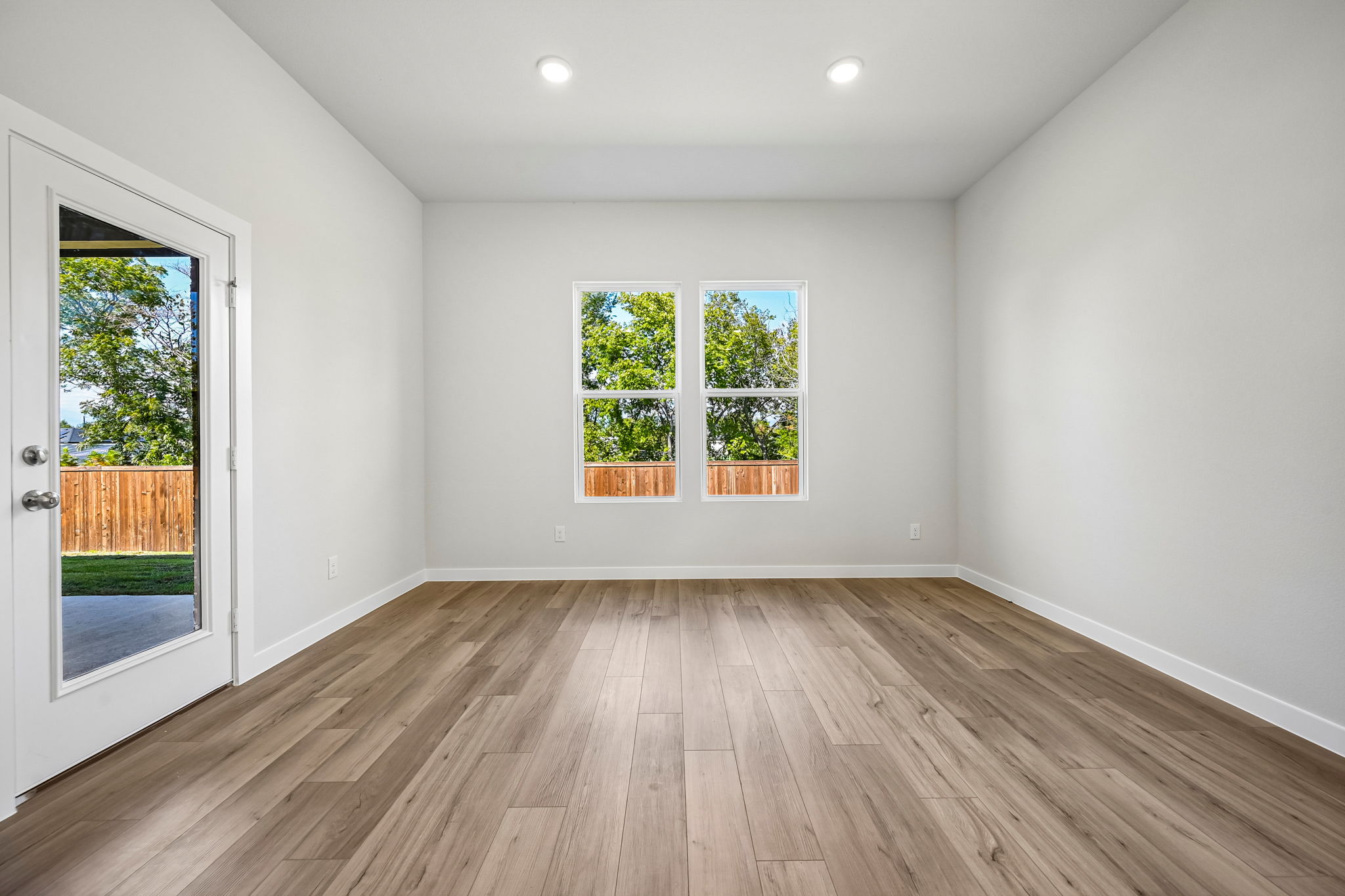 A room with a wood floor and a wood floor with a window.