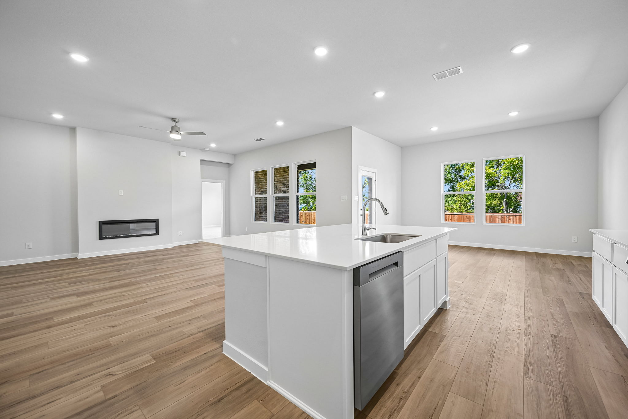 A kitchen with white cabinets.