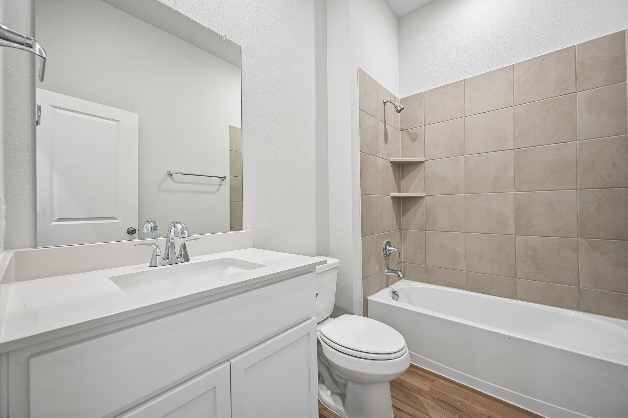 A bathroom with a tub sink and toilet.