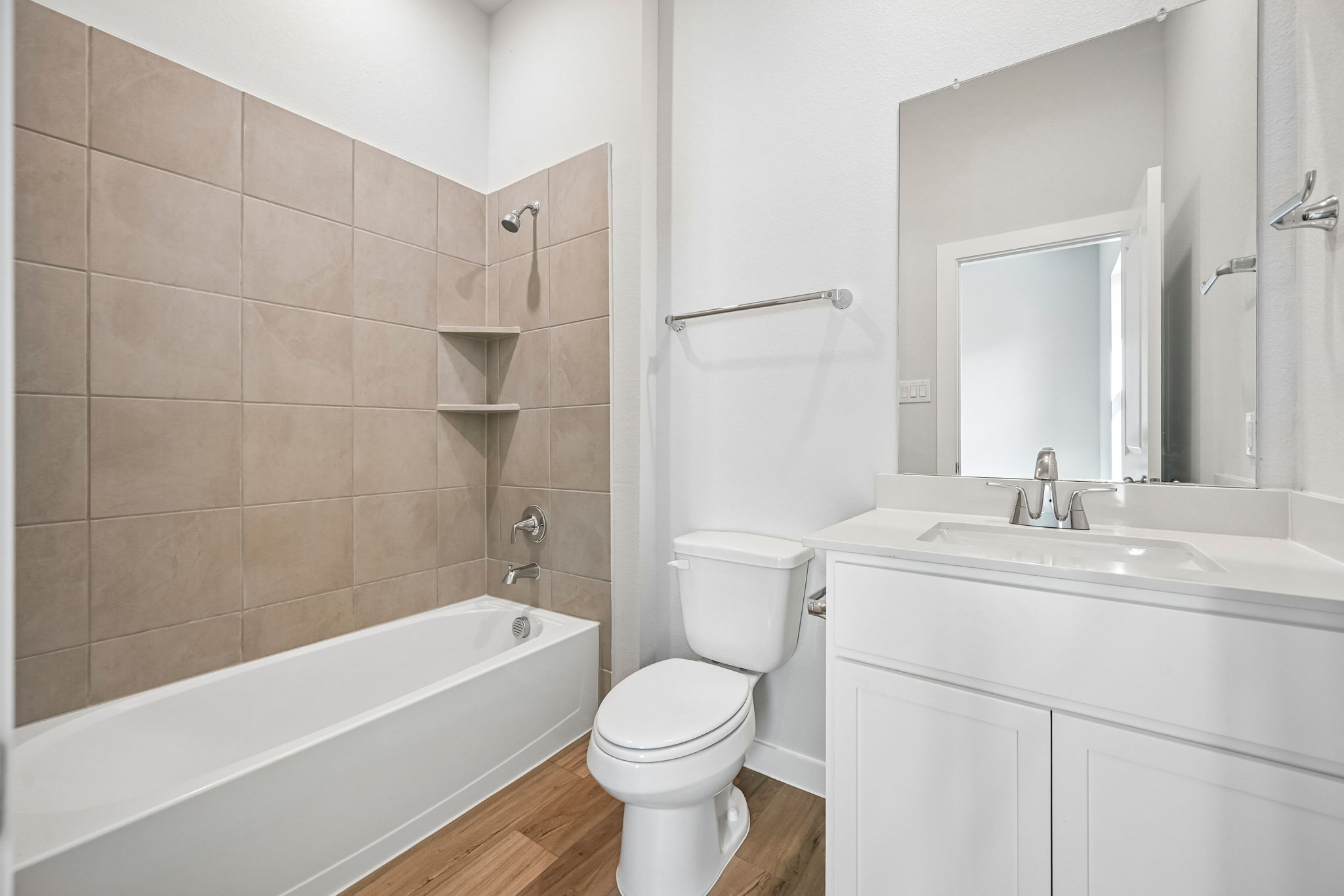 A bathroom with a tub toilet and sink.