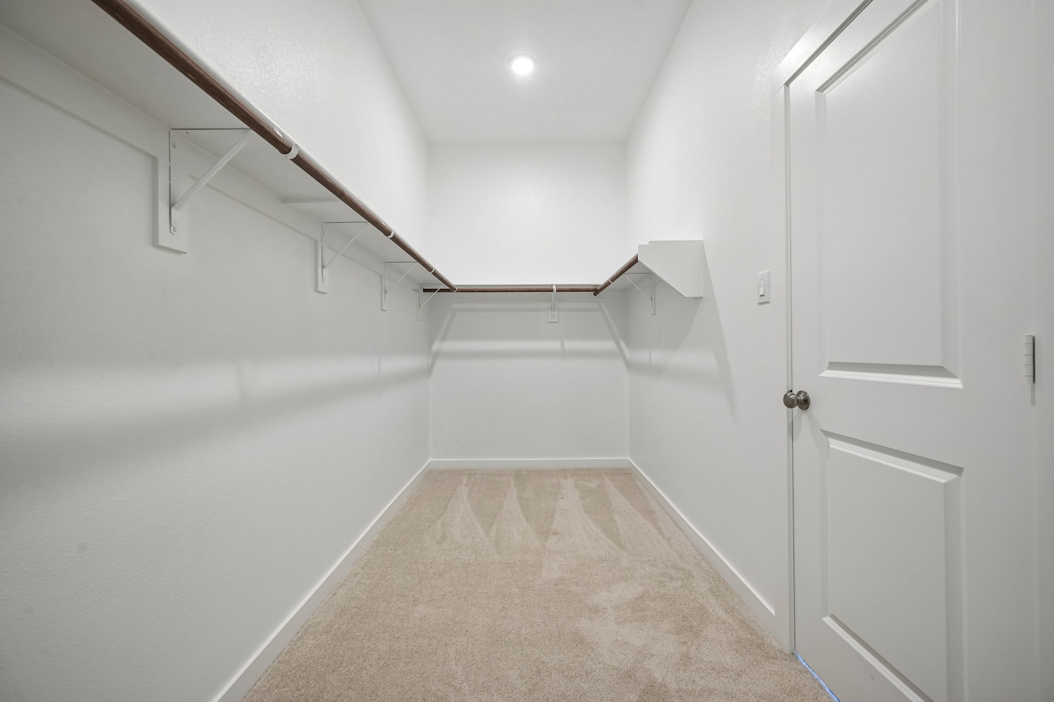 A hallway with white walls.
