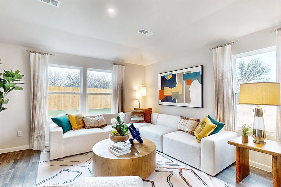 A living room with a white couch and a coffee table.