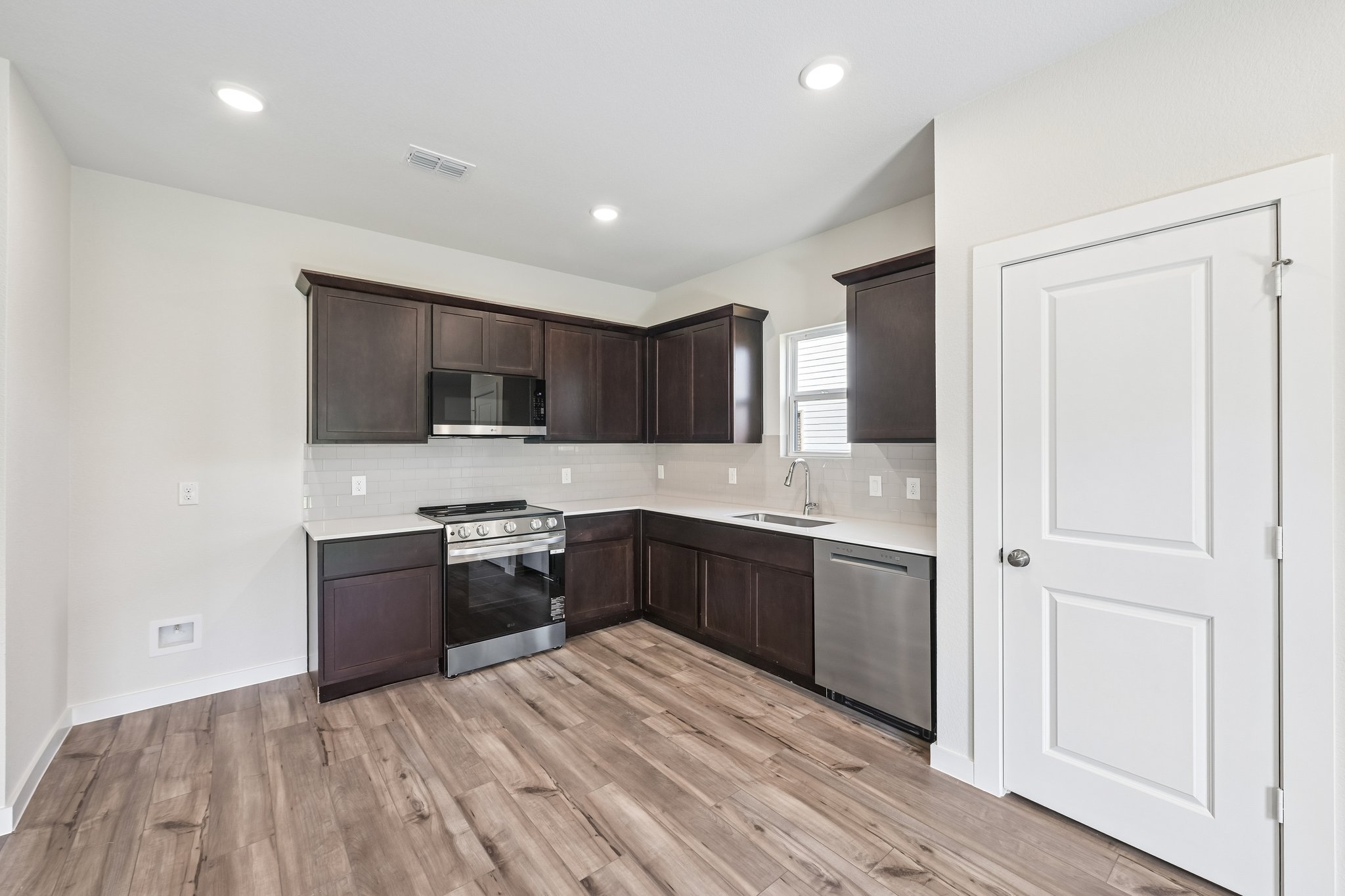 A kitchen with black cabinets.