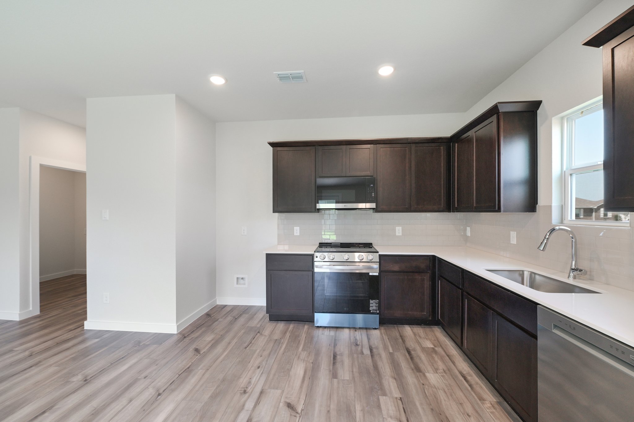 A kitchen with black cabinets.