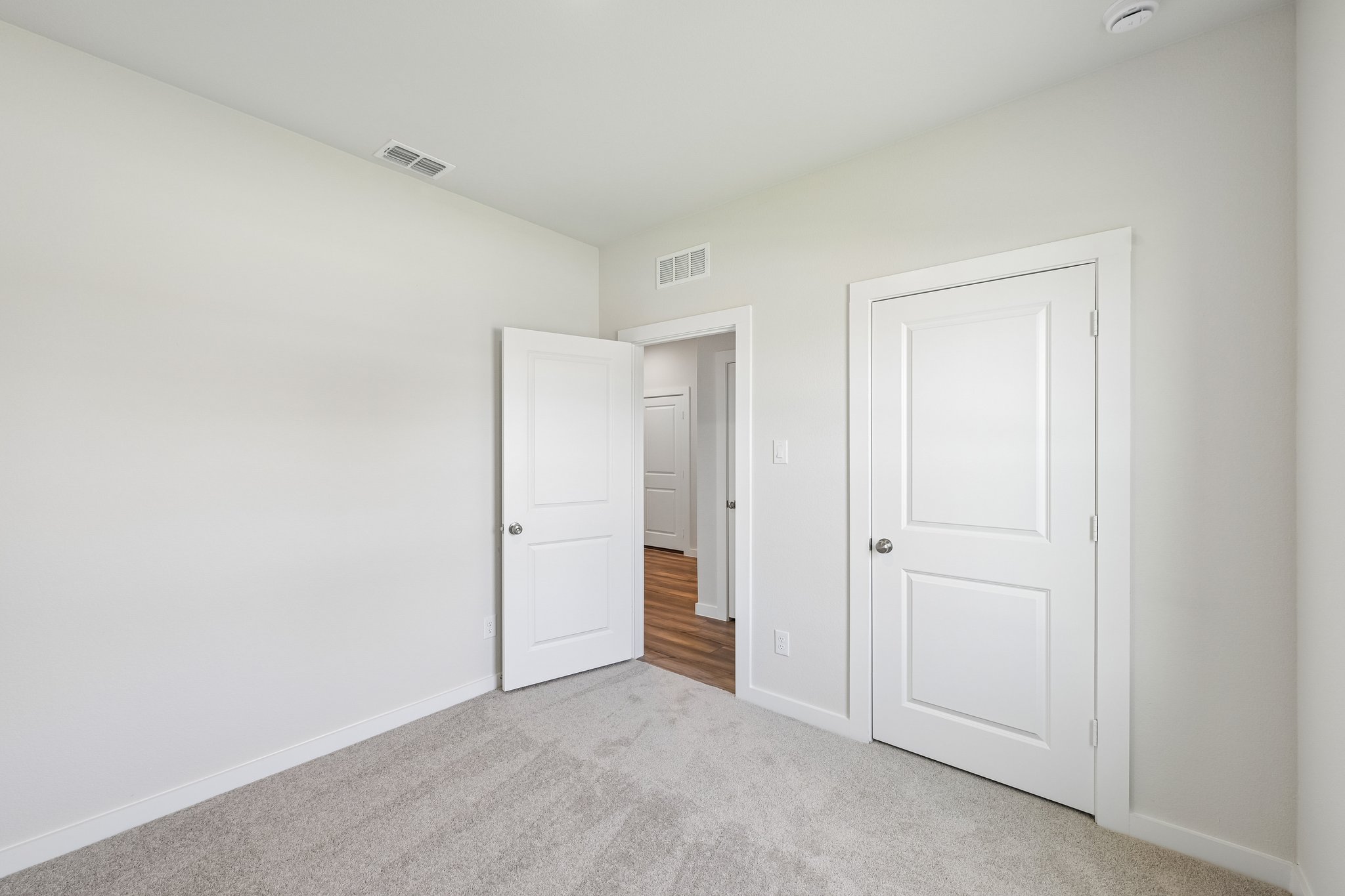 A hallway with white doors.