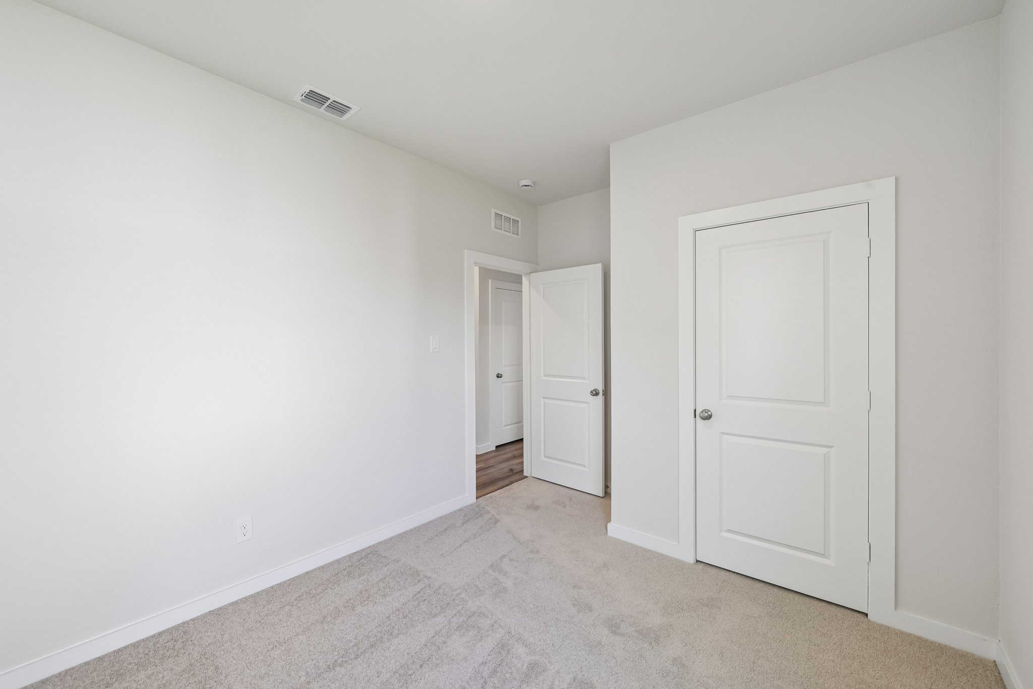 A hallway with white doors.