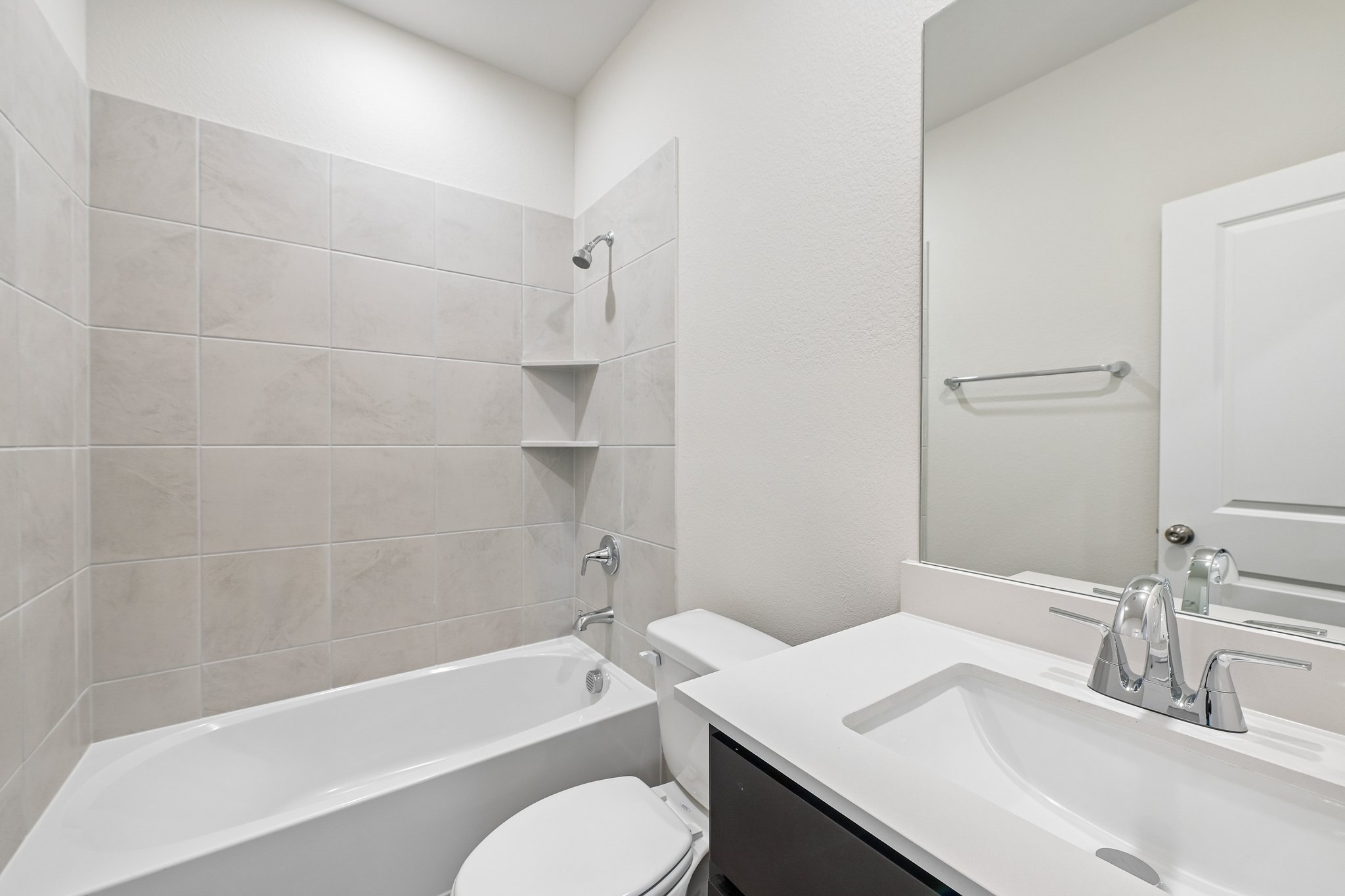 A bathroom with a tub sink and toilet.