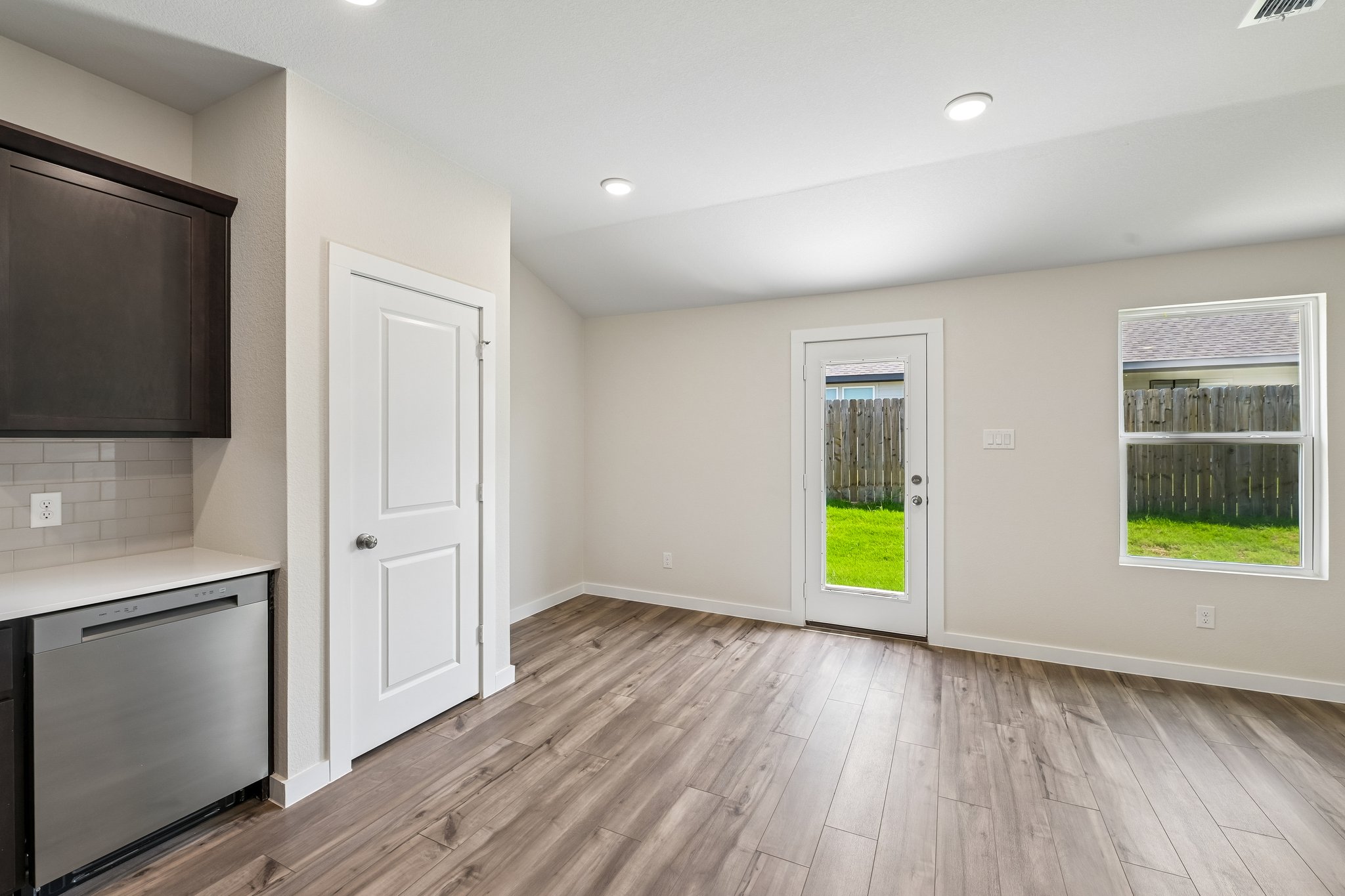 A room with a wood floor and white walls.