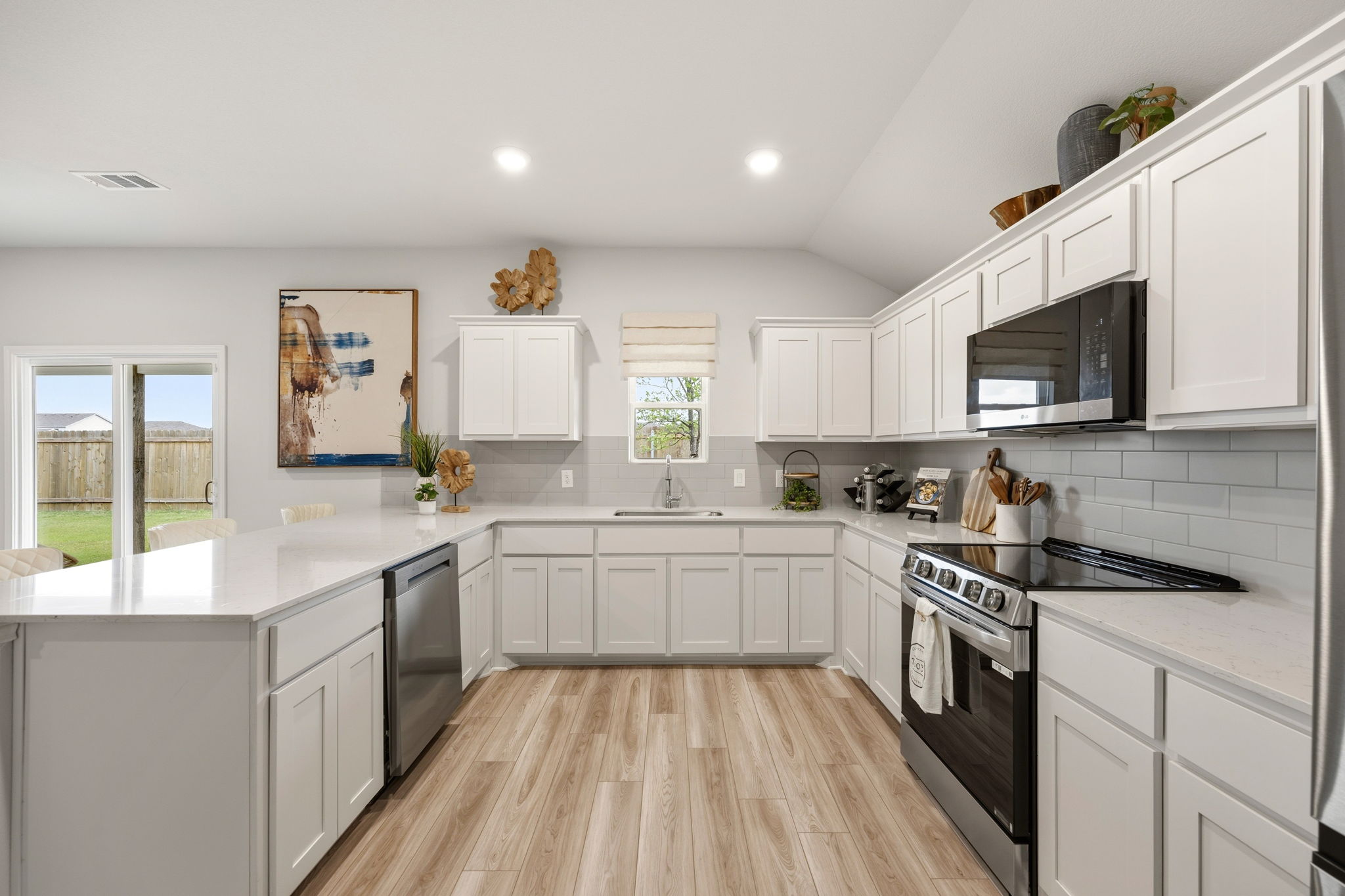 A kitchen with white cabinets.
