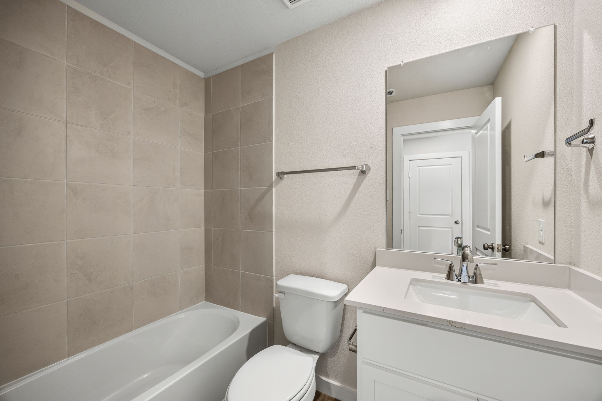 A bathroom with a tub sink and toilet.