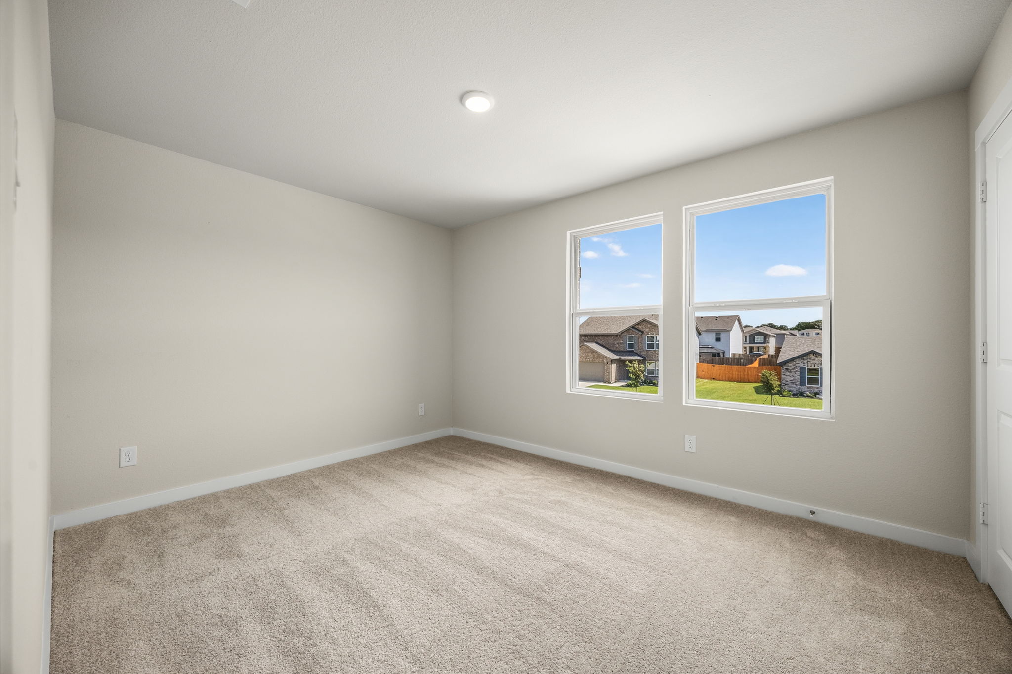 A room with a window and a carpet.