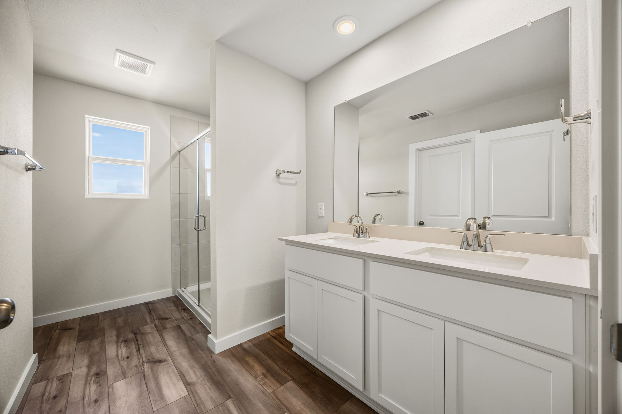 A bathroom with white cabinets.