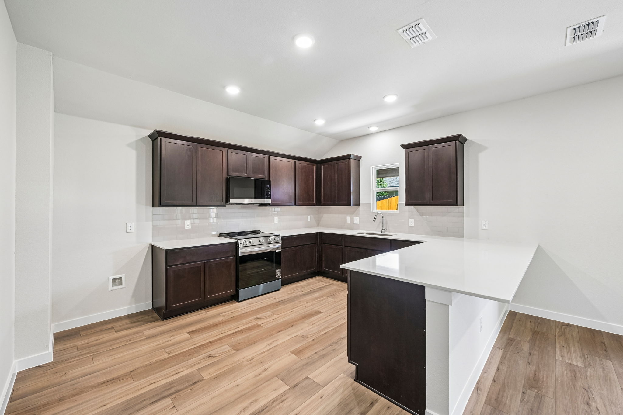 A kitchen with black cabinets.