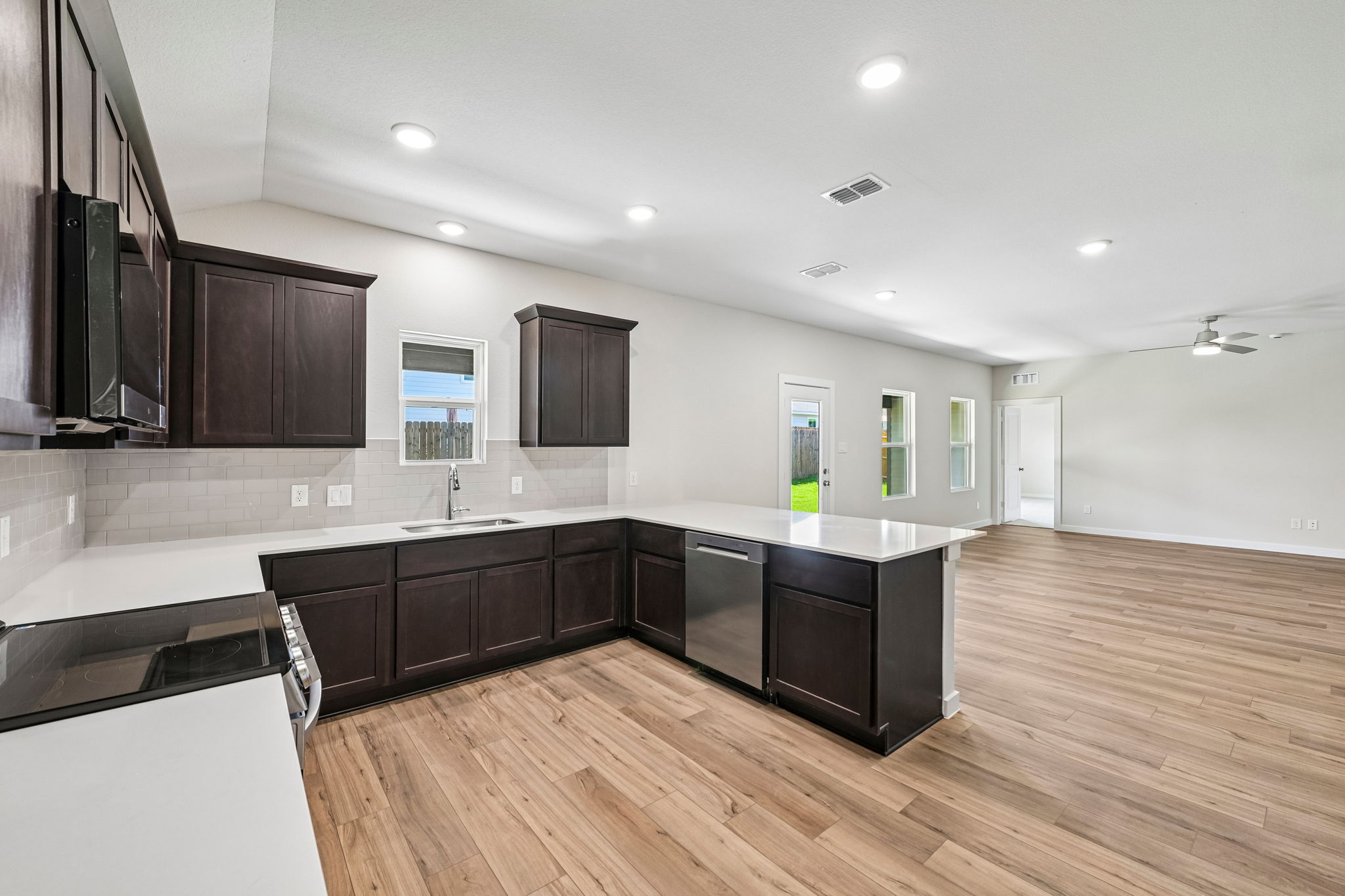 A large kitchen with black cabinets.