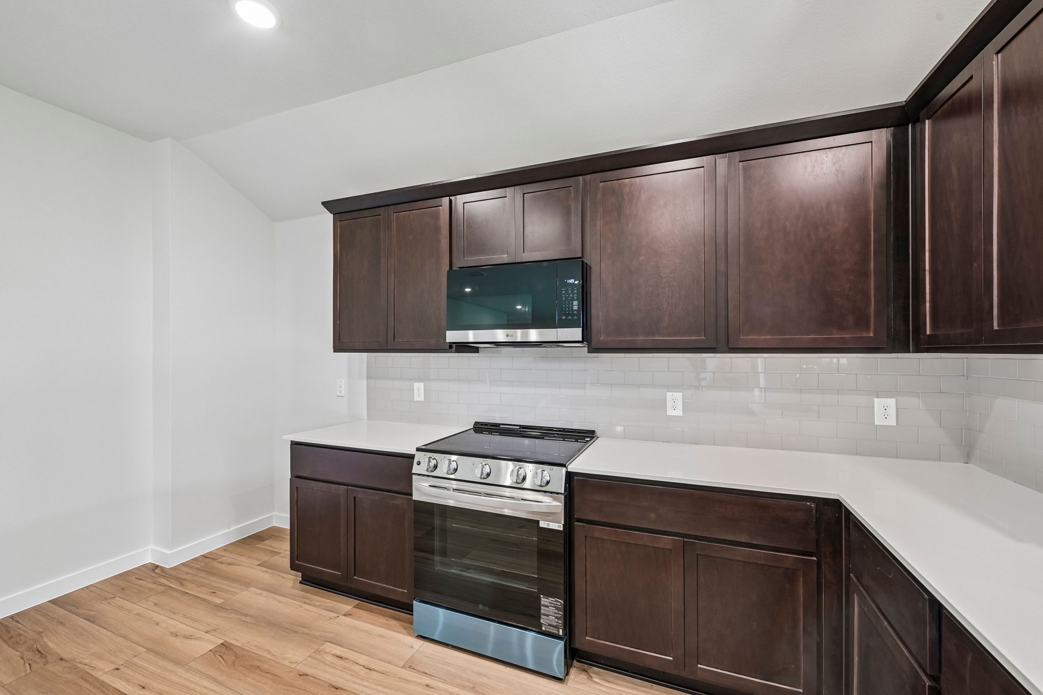 A kitchen with wooden cabinets.