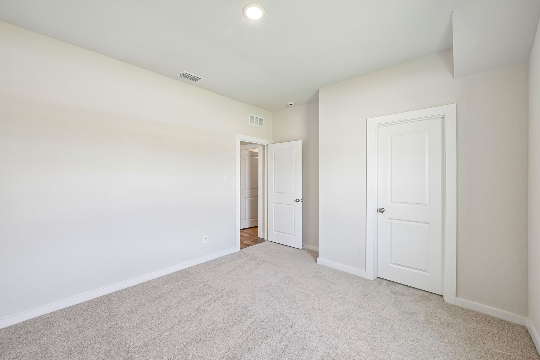 A hallway with white doors.