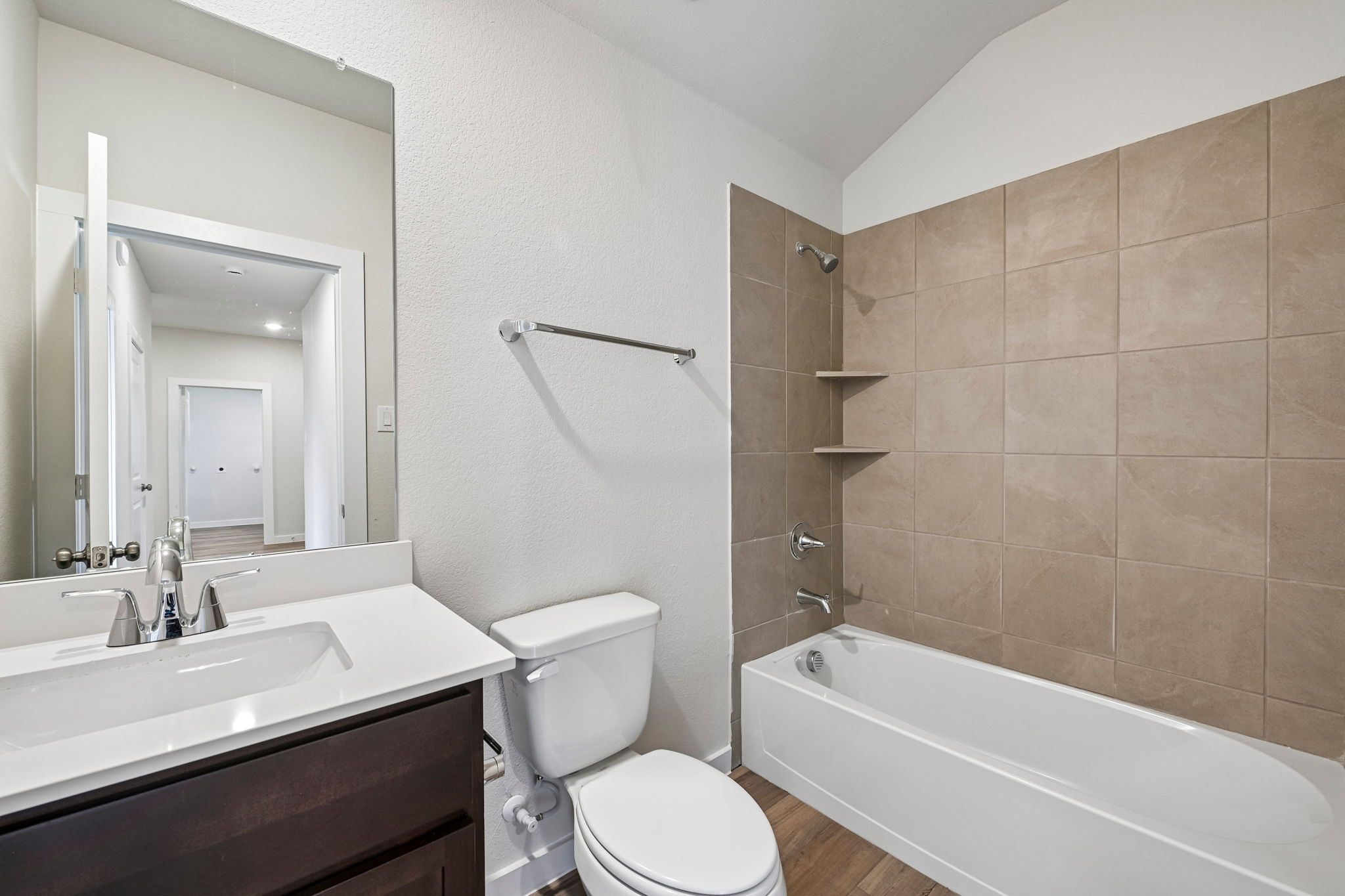 A bathroom with a tub toilet and sink.