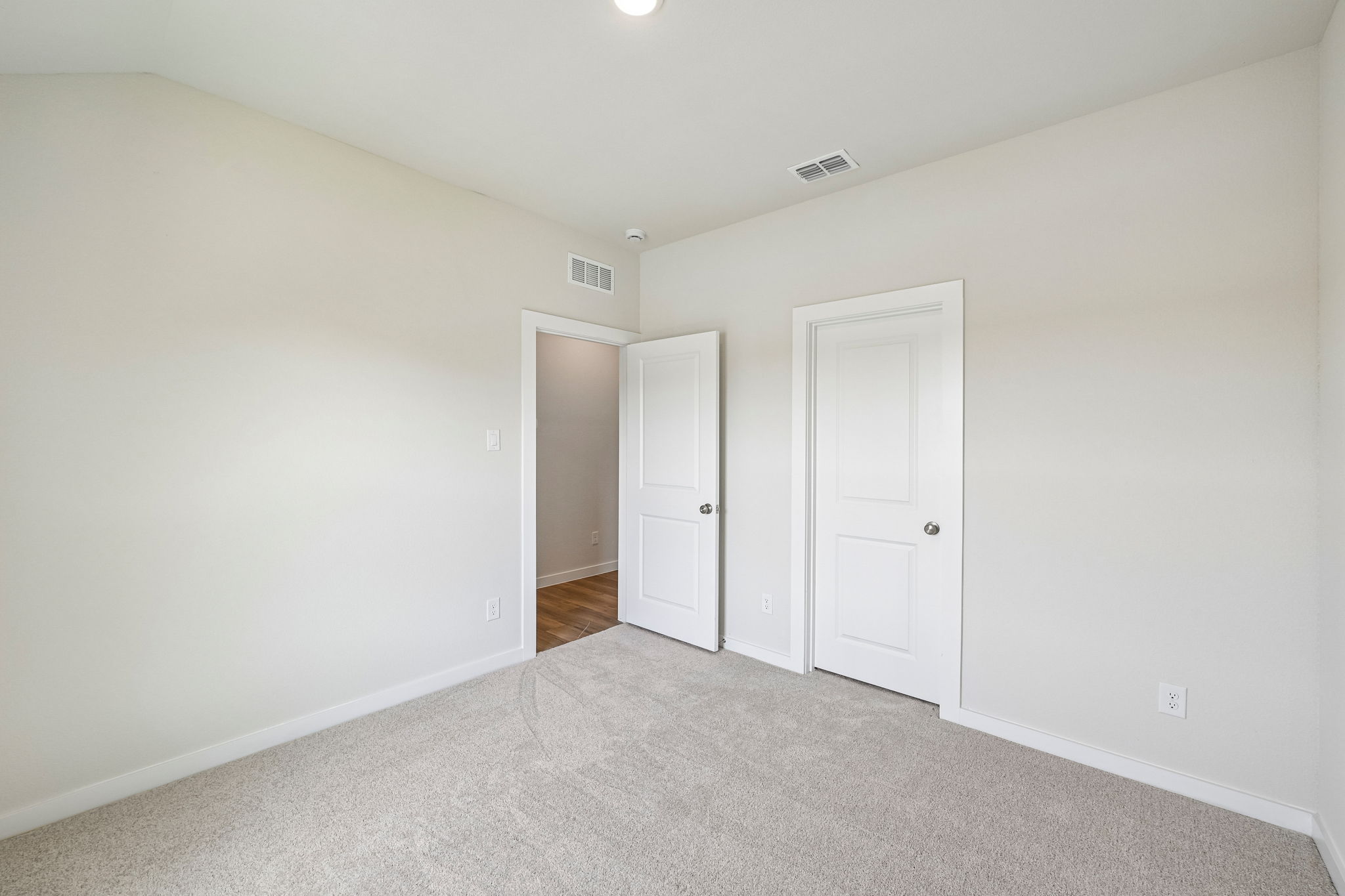 A hallway with white doors.