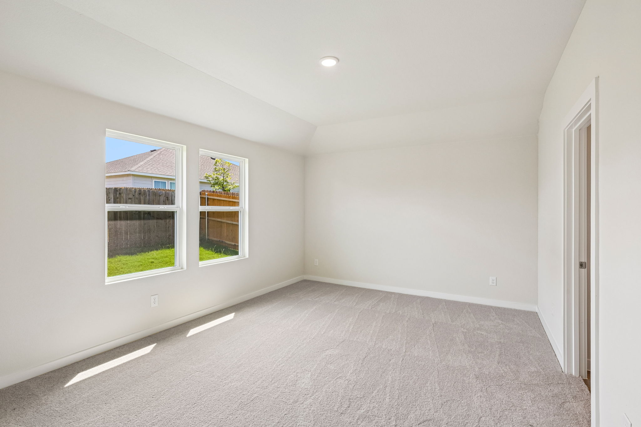 A room with a window and a carpet.