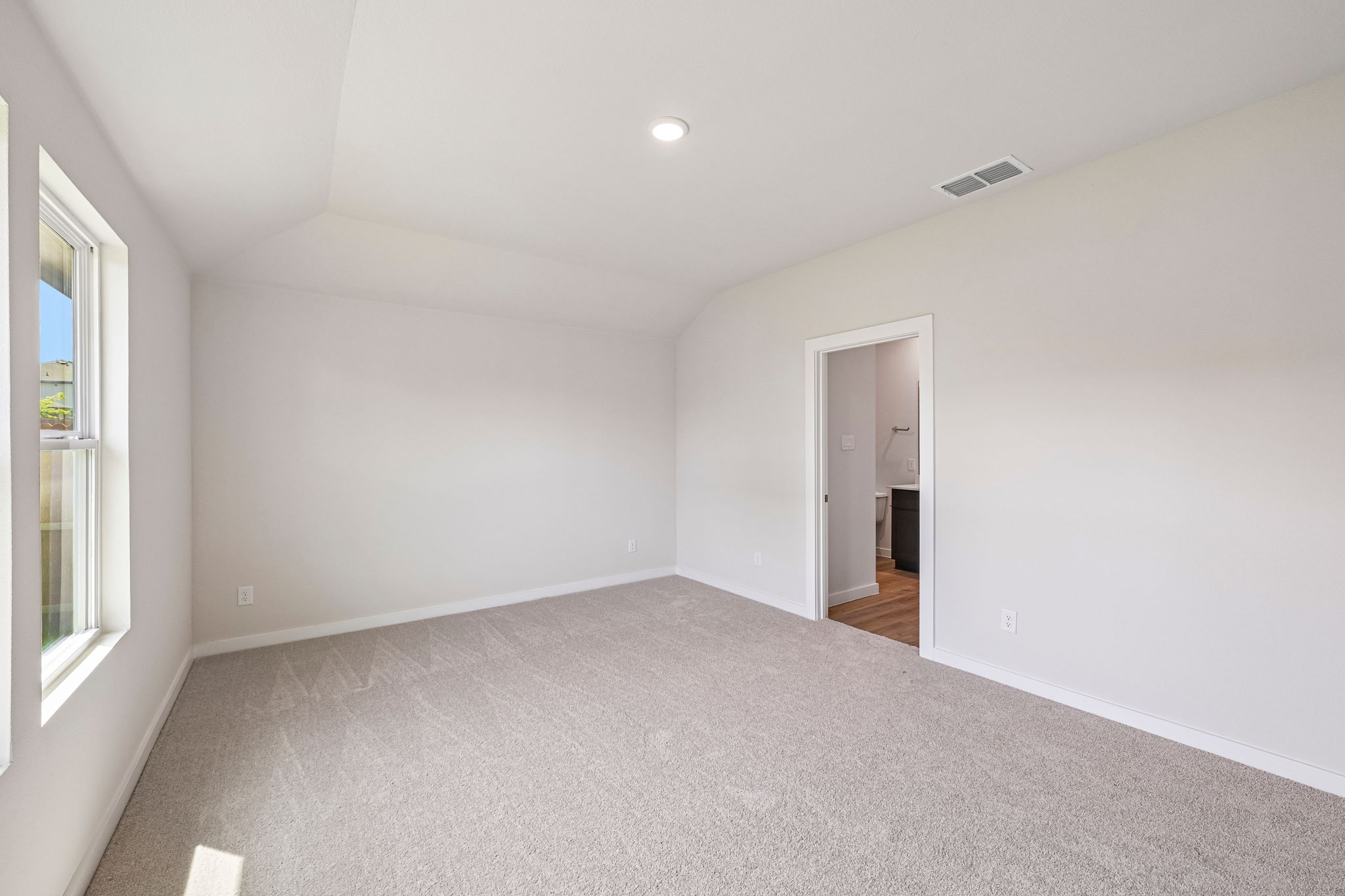 A hallway with white walls.