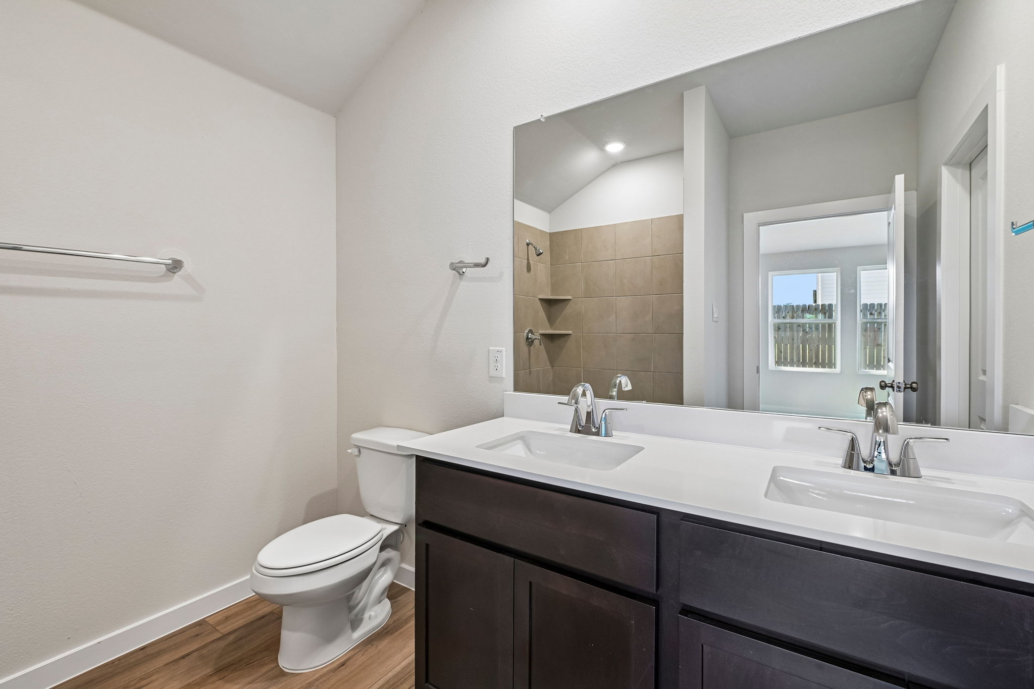 A bathroom with a large mirror.