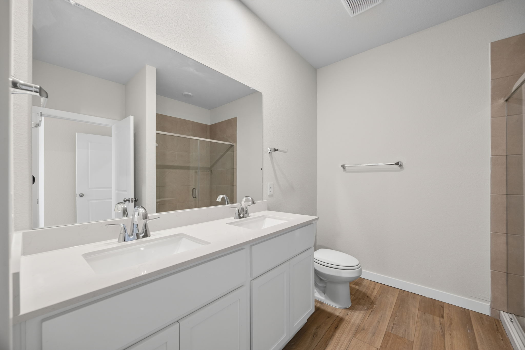 A bathroom with a large mirror.