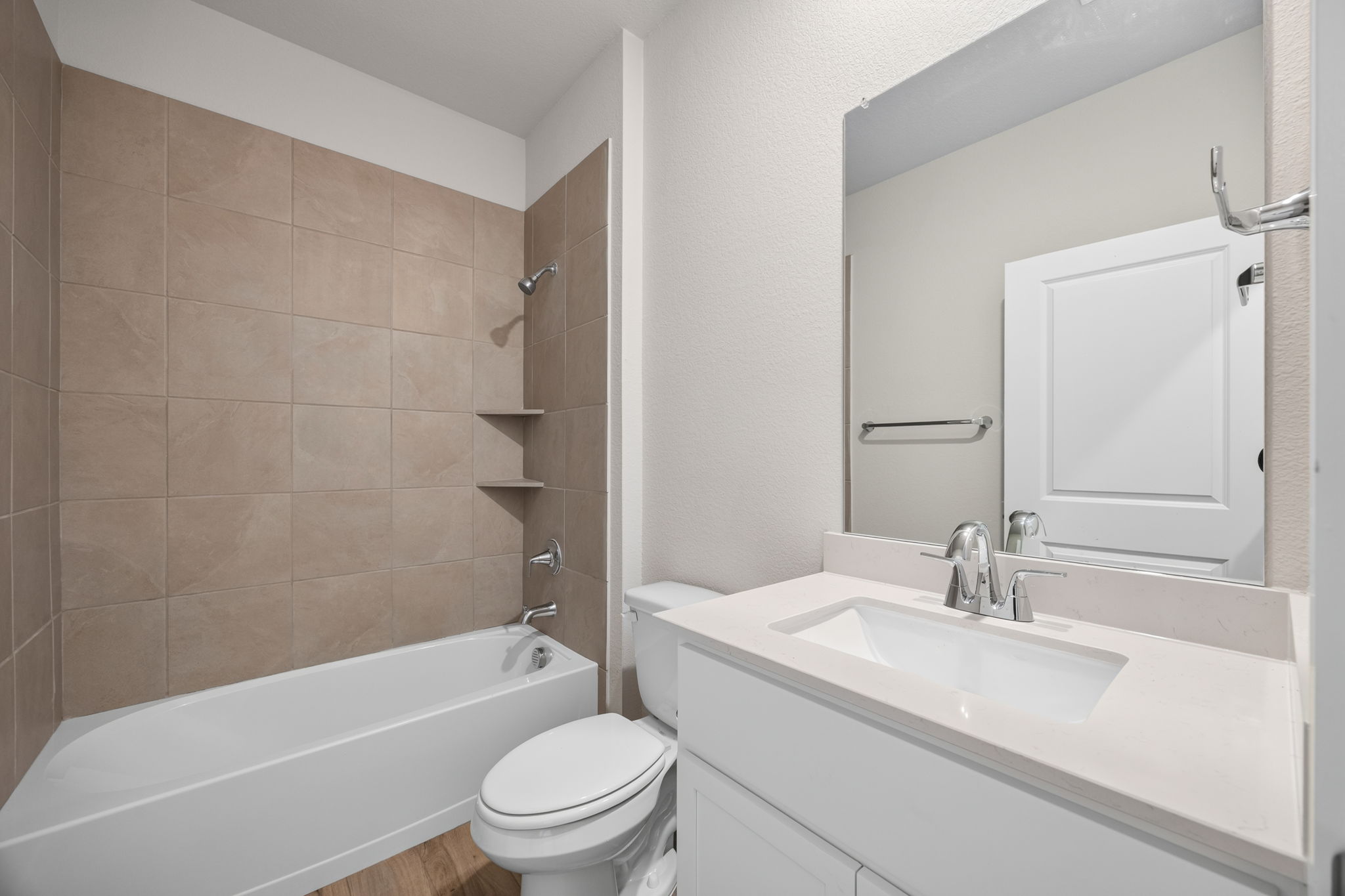 A bathroom with a tub sink and toilet.