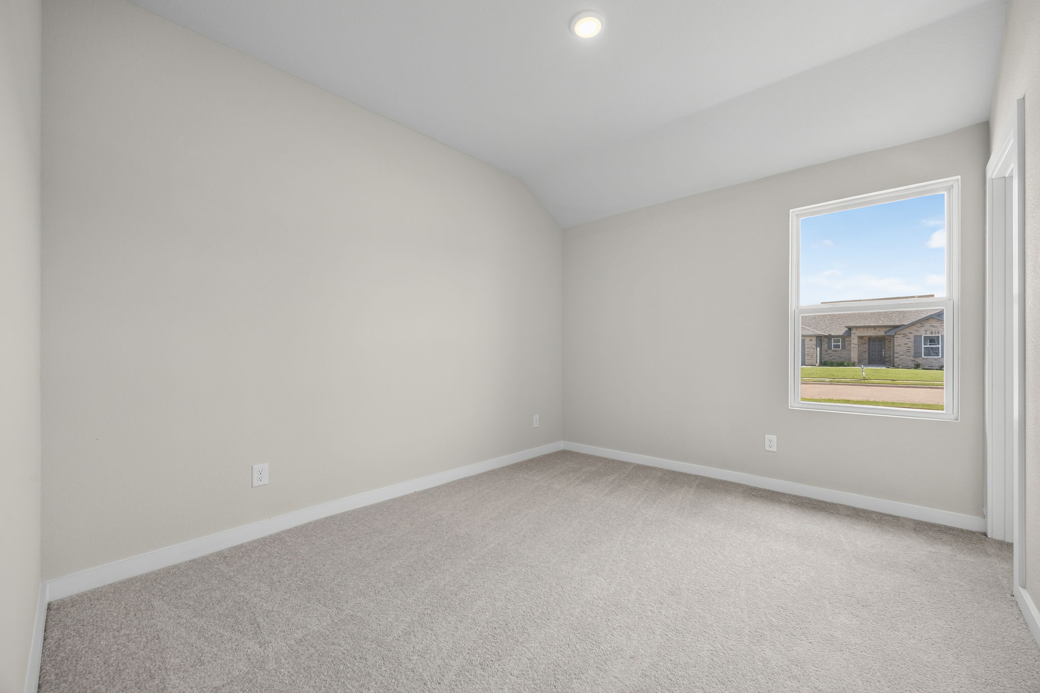 A room with a window and a carpet.