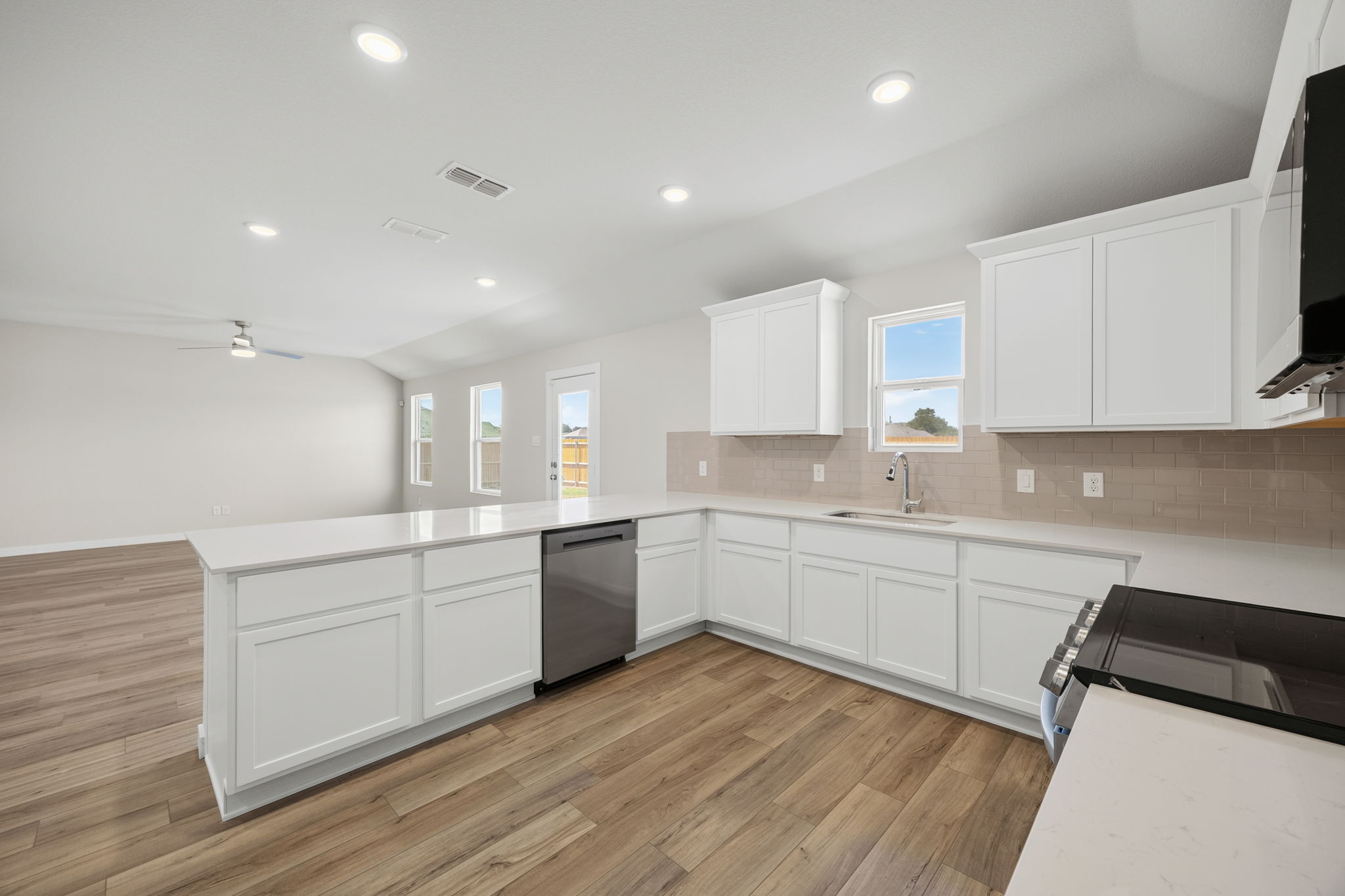 A kitchen with white cabinets.