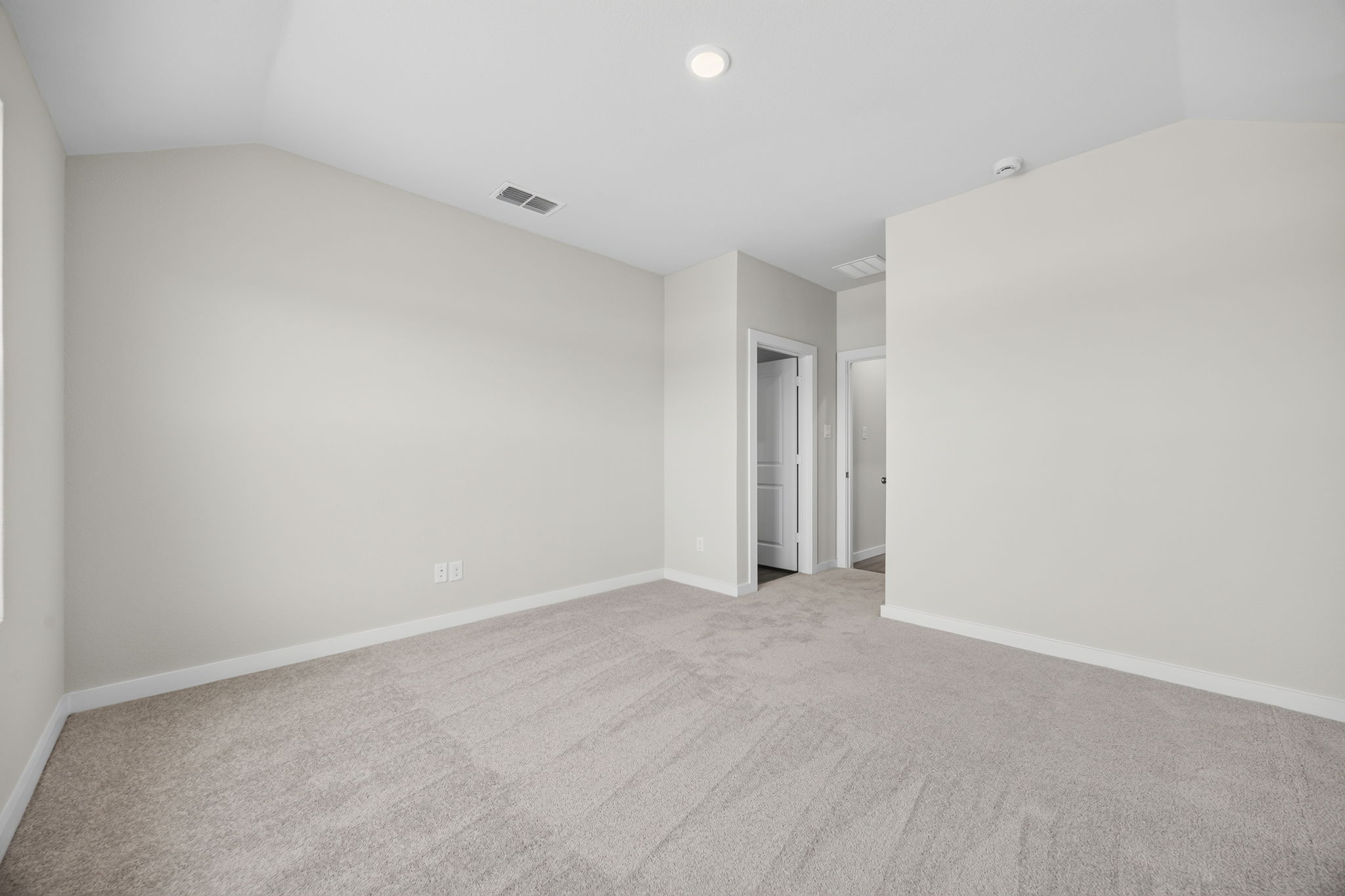 A hallway with white walls.