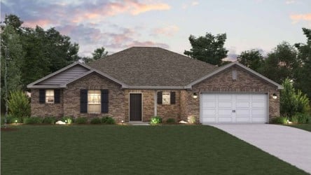 A house with a garage and a lawn in front of it.