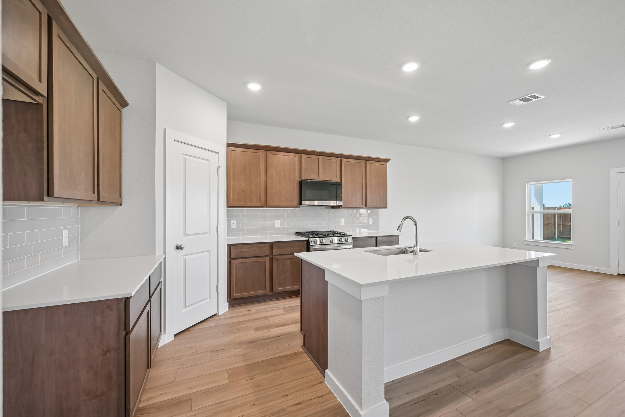 A kitchen with wooden cabinets.