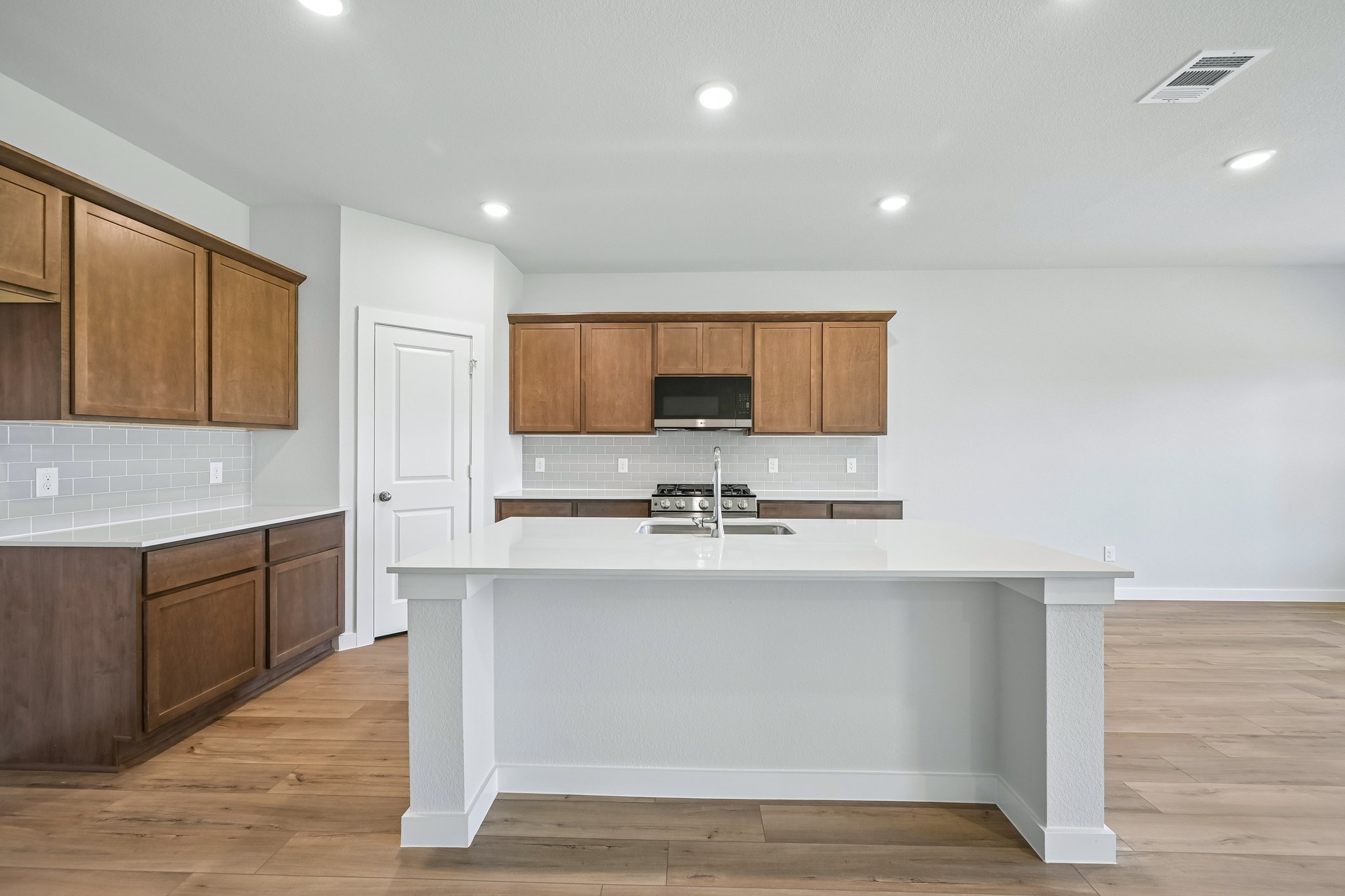 A kitchen with wooden cabinets.