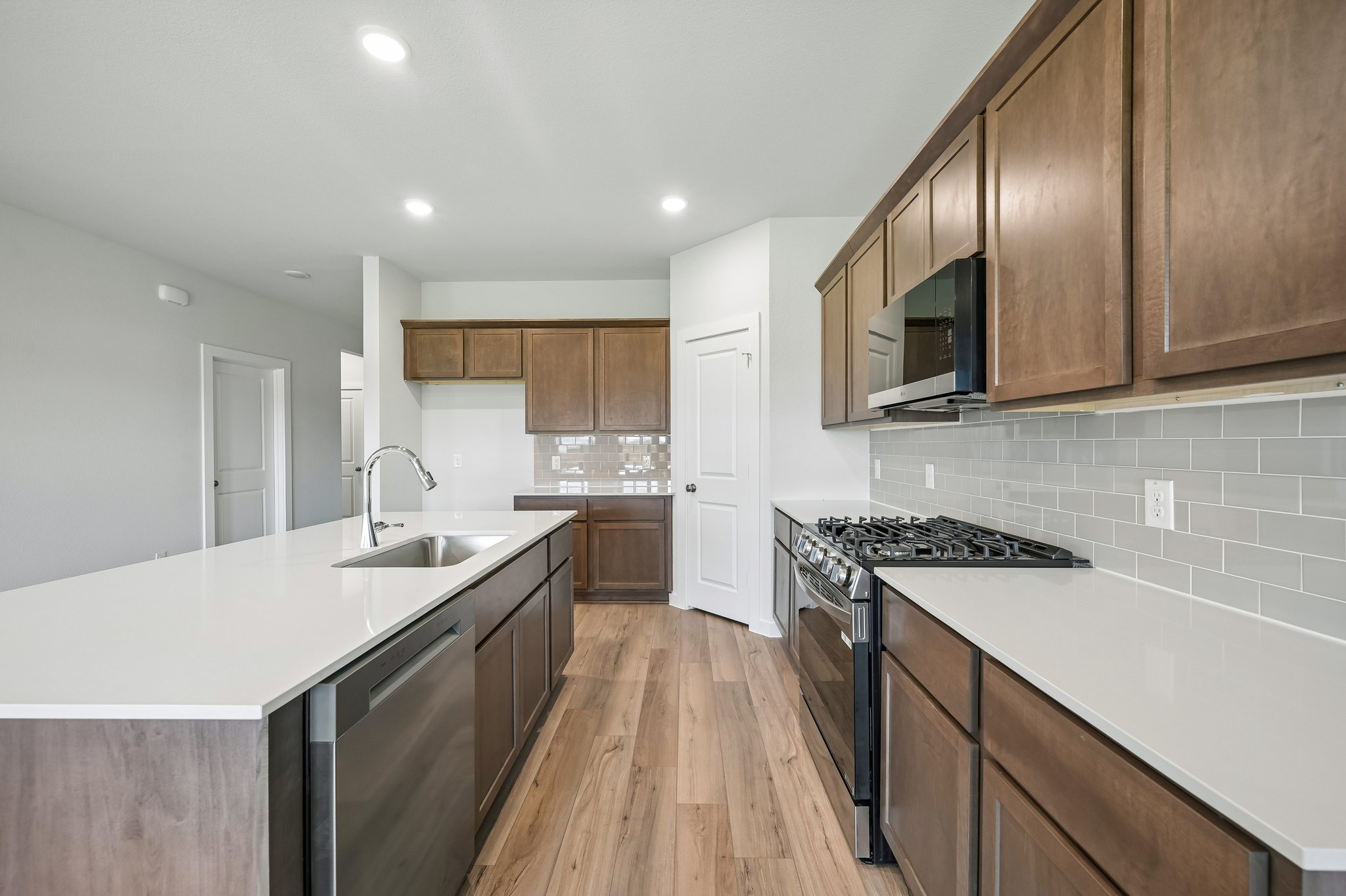 A kitchen with wooden cabinets.