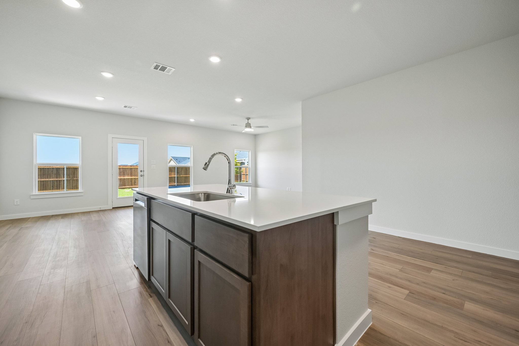 A kitchen with a wood floor.