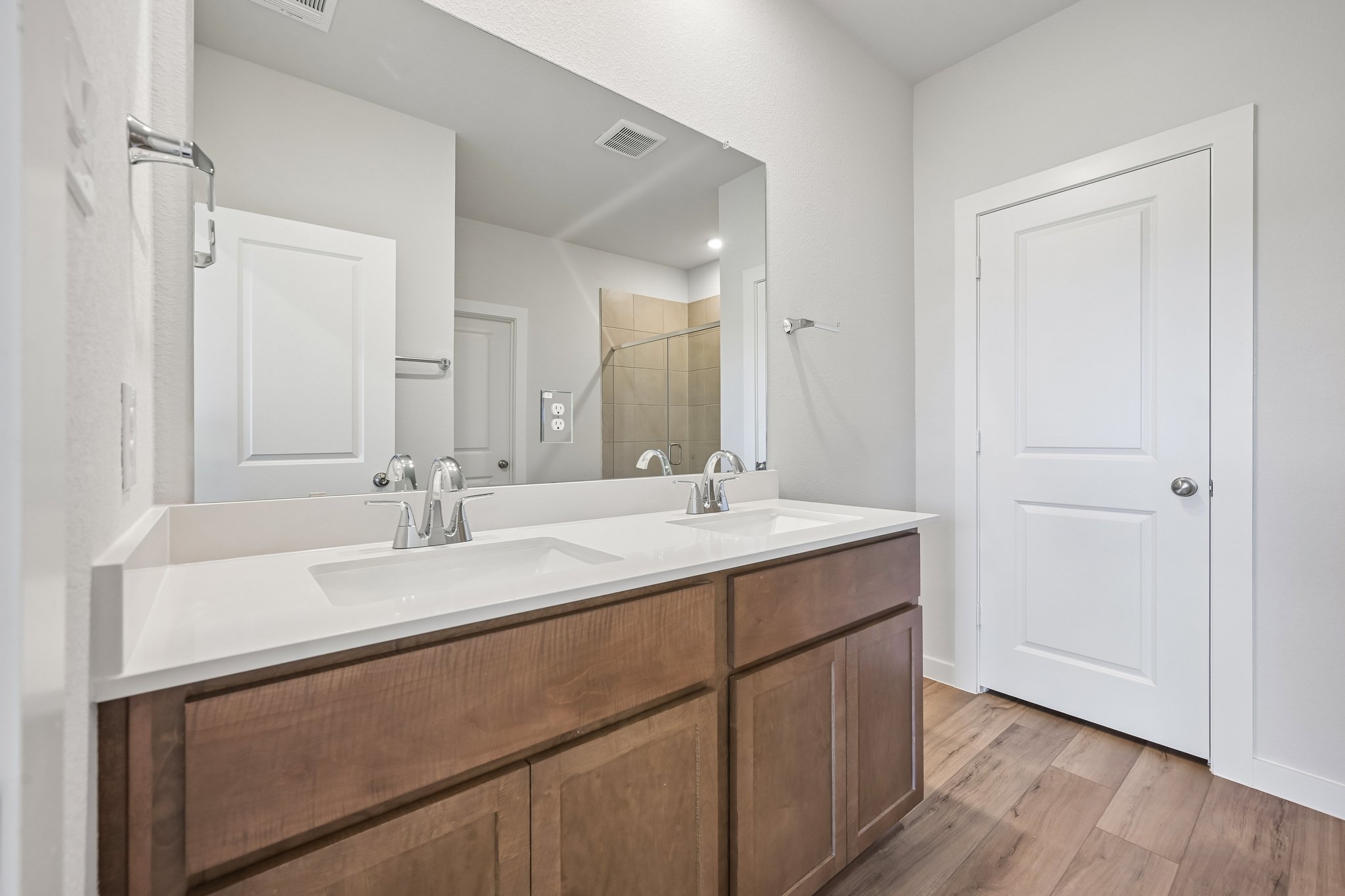 A bathroom with a large mirror.
