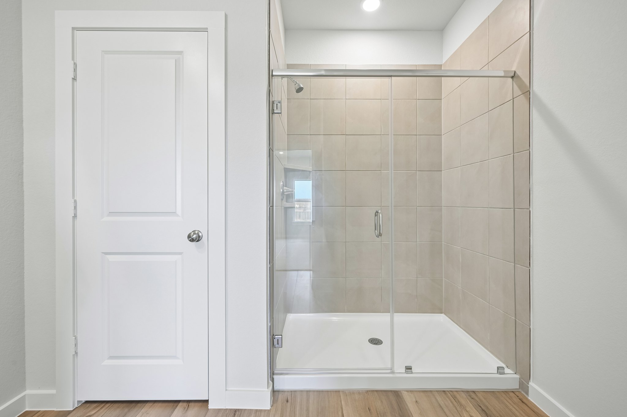 A shower with a glass door.