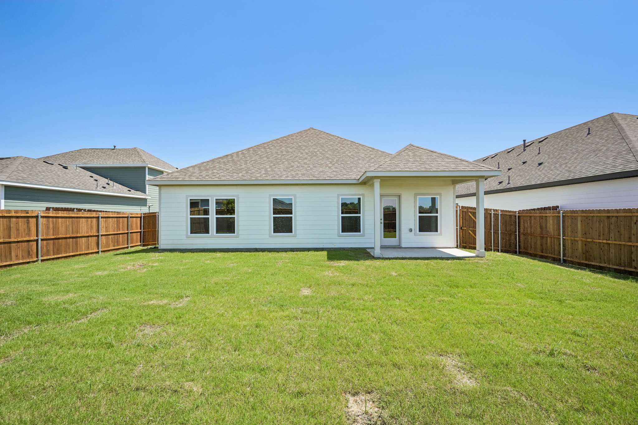 A house with a fence and grass.
